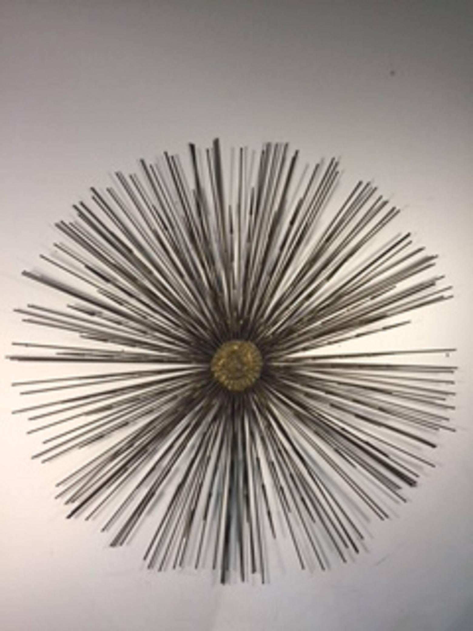 An exceptional Curtis Jere starburst wall-mounted dimensional sculpture with layers of metal spokes, circa 1970.