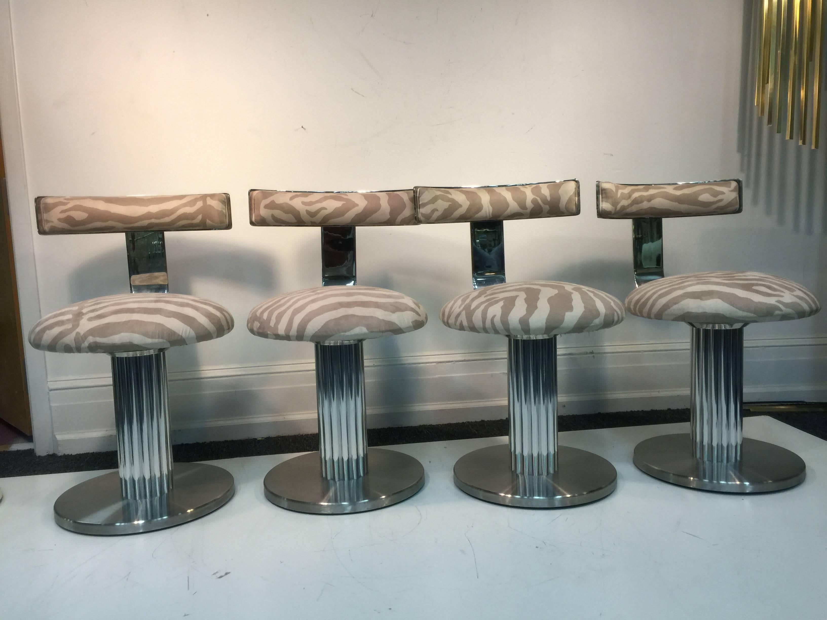 A rare and exceptional set of four bar stools or side chairs with brushed chrome fluted bases and beautiful leather animal upholstery by Design Institute America. Labeled DIA, 1985. Can be sold in pairs for $11,500 each.