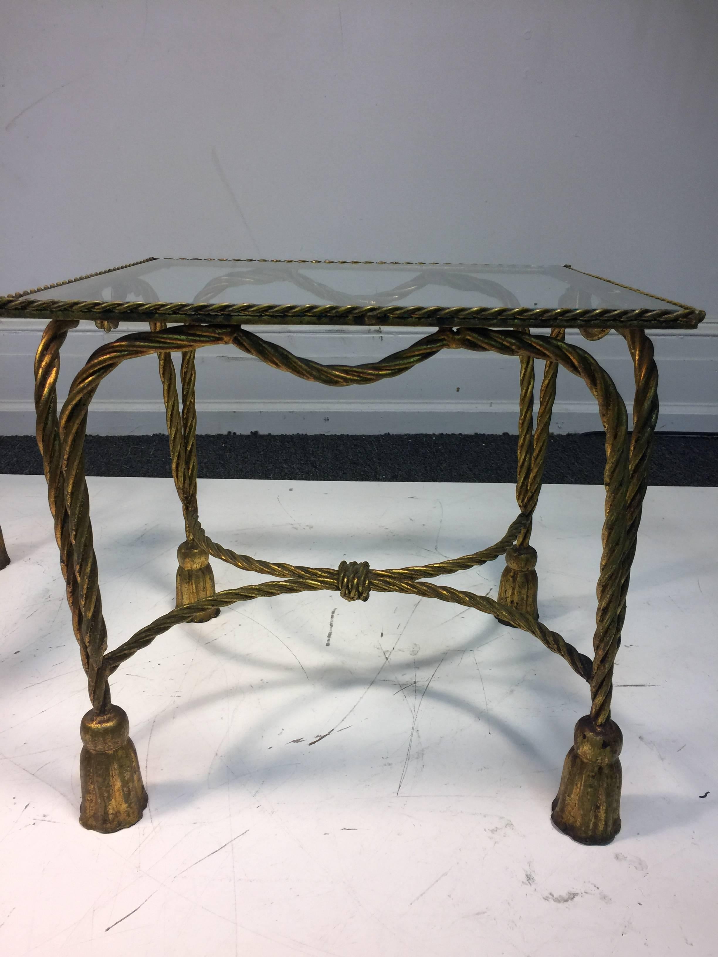 A gorgeous pair of Italian gilt metal side or accent tables with rope and tassel motif in the manner of Maison Jansen, circa 1970. Good vintage condition with age appropriate wear.