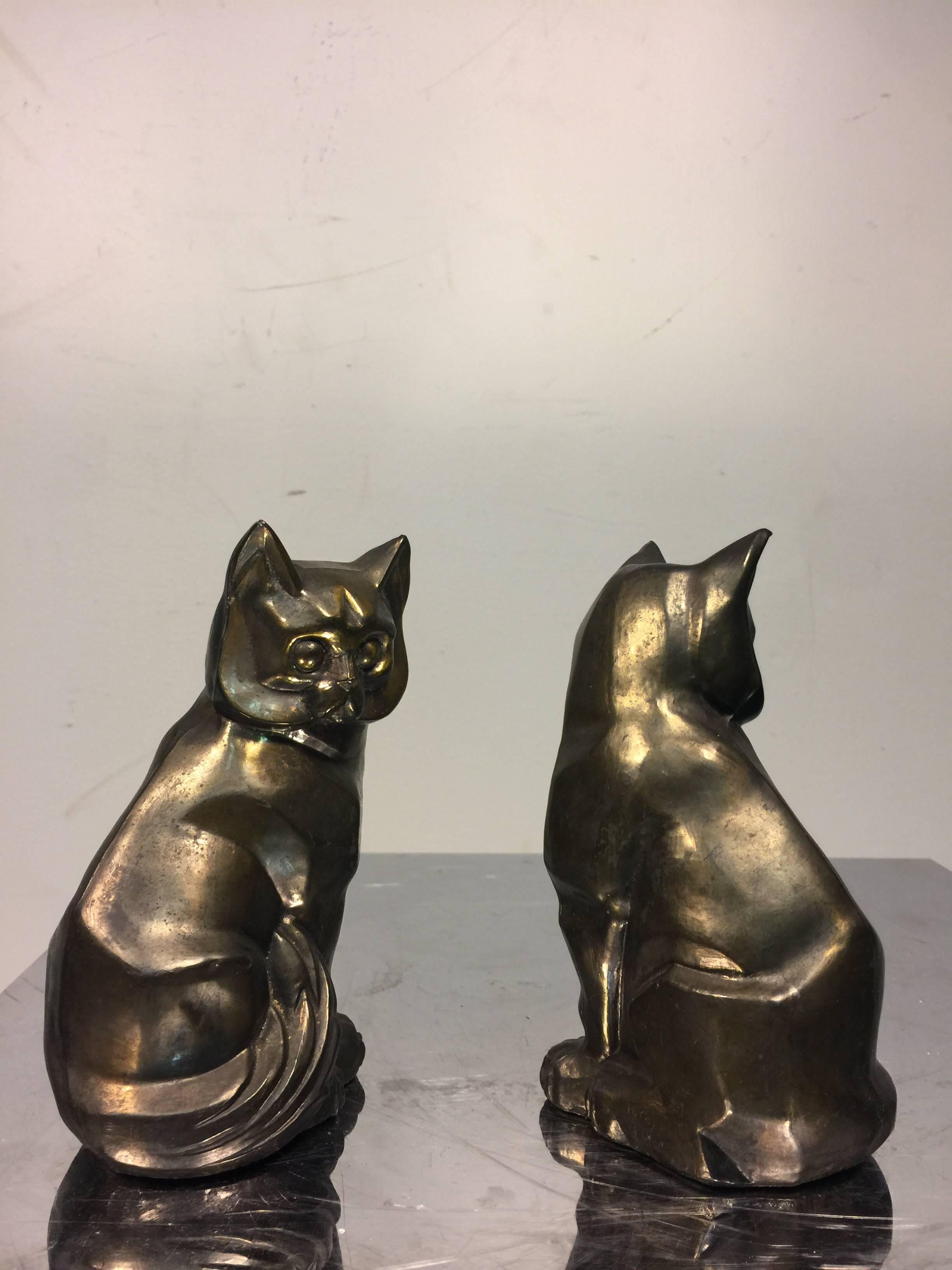 A terrific pair of Art Deco style cast metal cubist cat form bookends, circa 1970. Good condition with age appropriate wear.