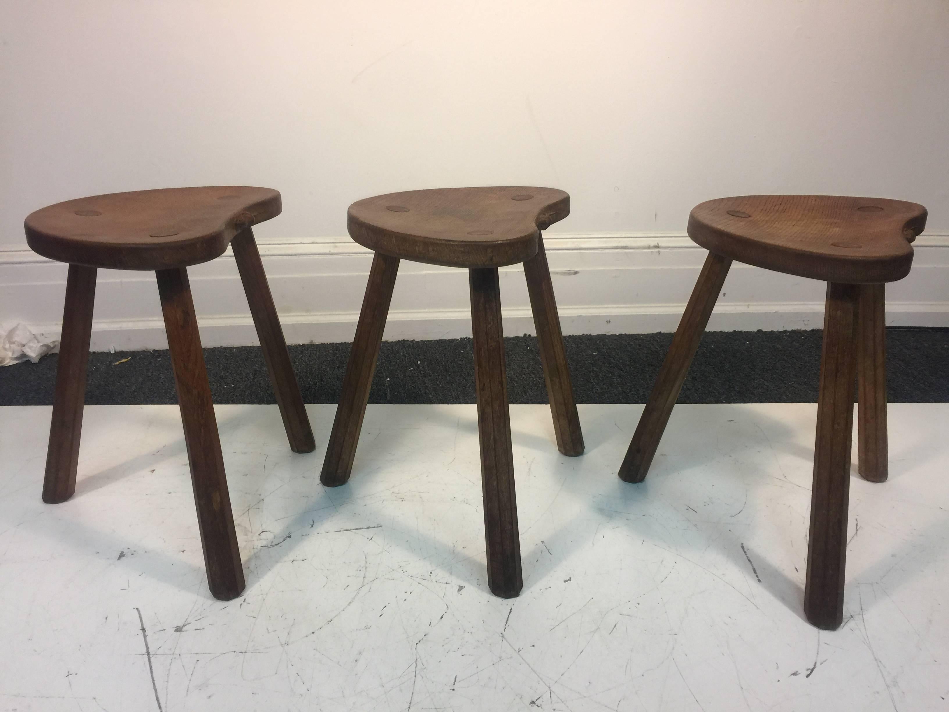 A very rare and fantastic set of three Robert Mouseman Thompson kidney-shaped top milking stools with carved mouse on each seat, circa 1970s, England. Good vintage condition with age appropriate wear.