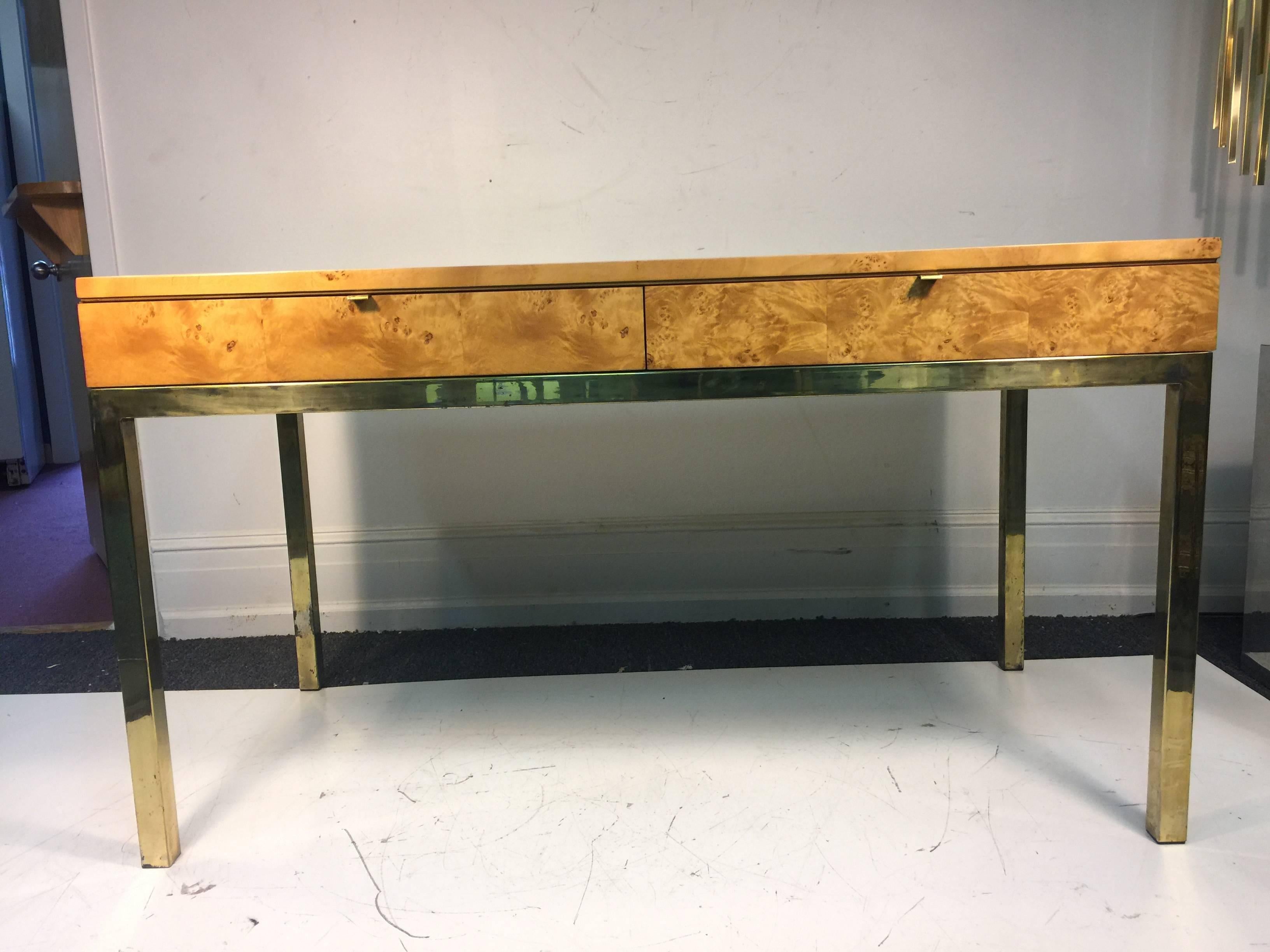 A magnificent Milo Baughman burl wood desk, or console table with two drawers, and beautiful brass base, circa 1970. Good vintage condition with age appropriate wear and patina.