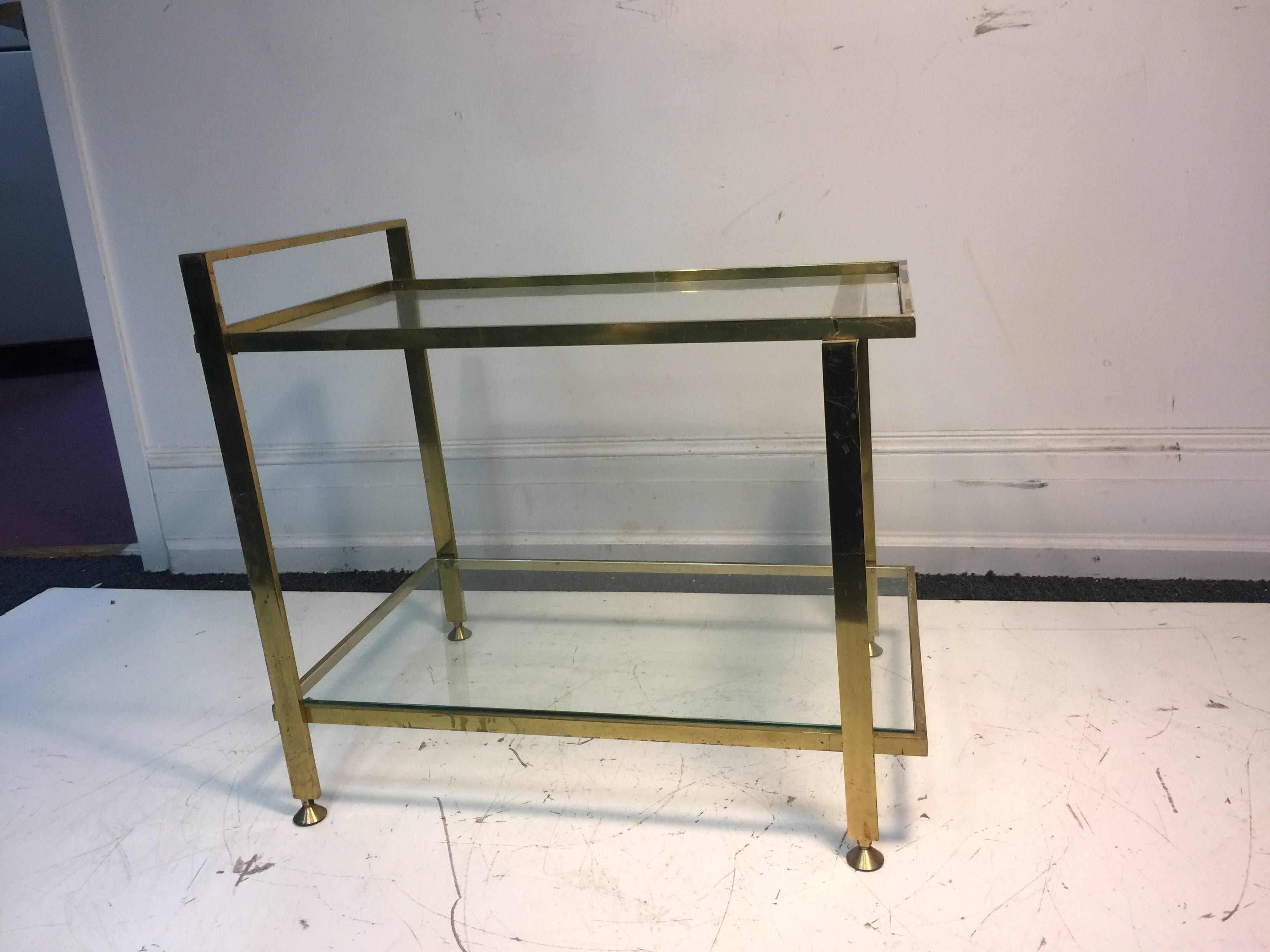 An elegant, two-tier, Italian brass bar cart, circa 1970. Good vintage condition with some wear to the brass.