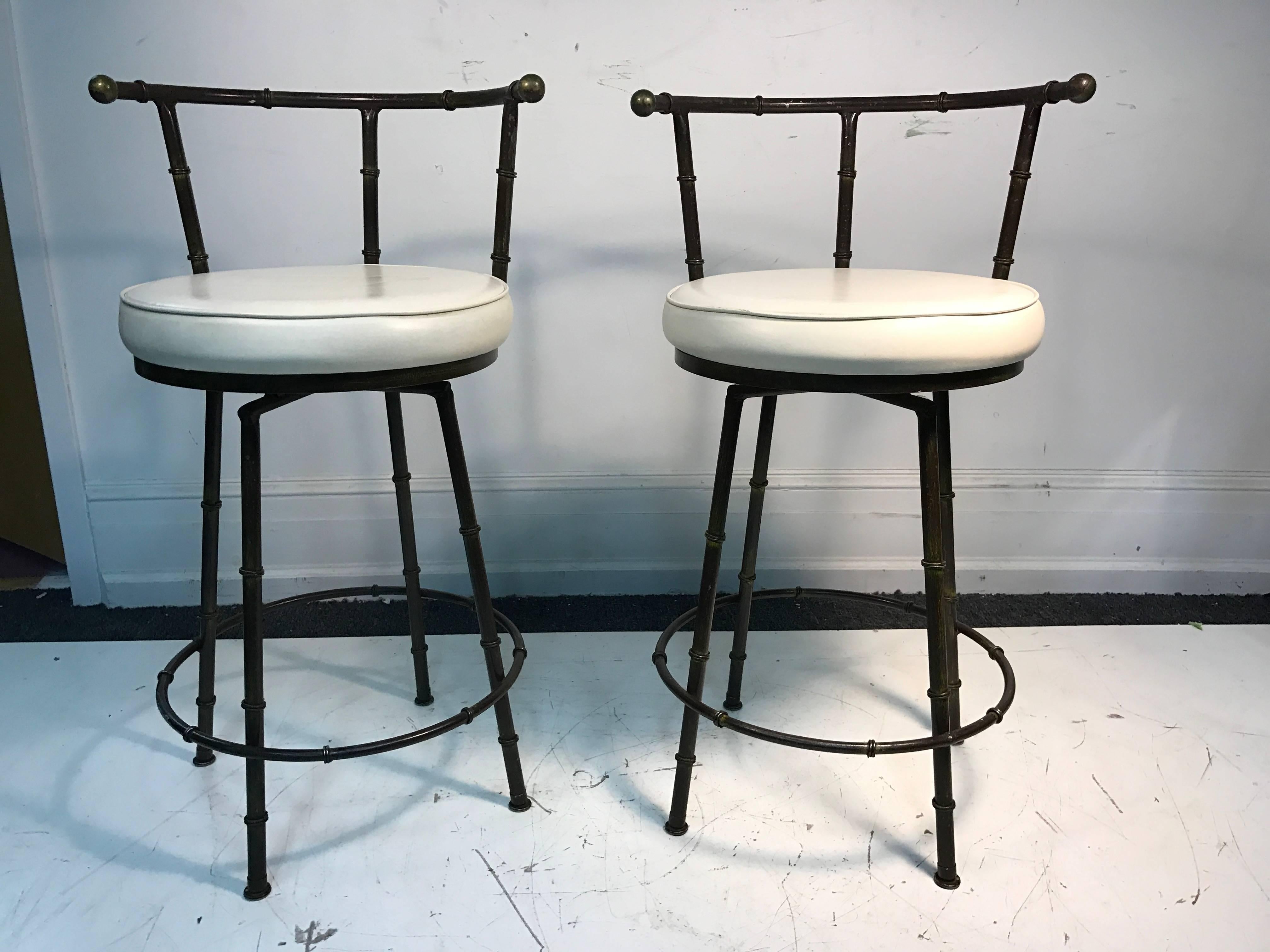 A gorgeous pair of Giacometti style, mixed-metal, faux bamboo bar stools with white vinyl seats, circa 1970. Good vintage condition.