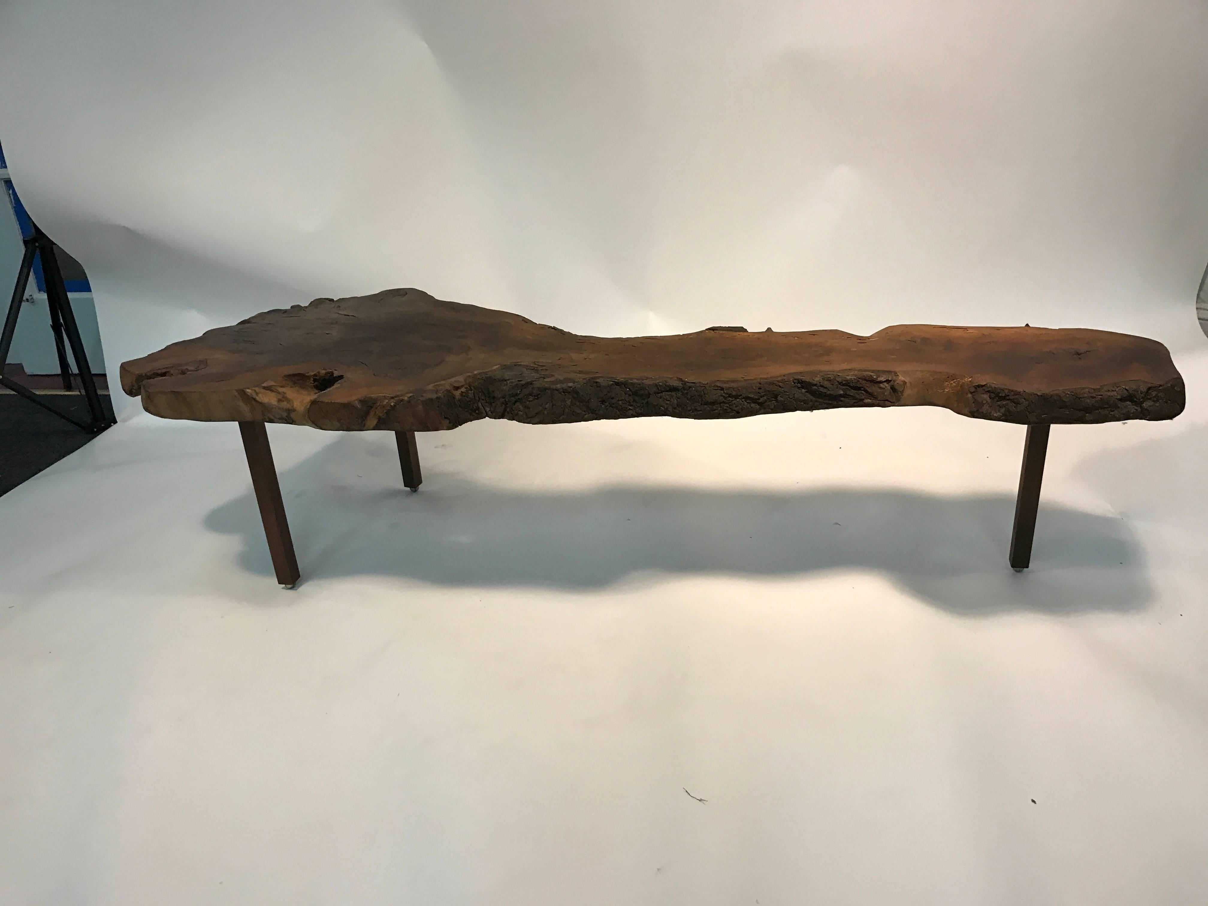 A gorgeous live edge coffee table  in the manner of. George Nakashima with beautiful detail and wood grain, circa 1960. Good vintage condition with natural wear.