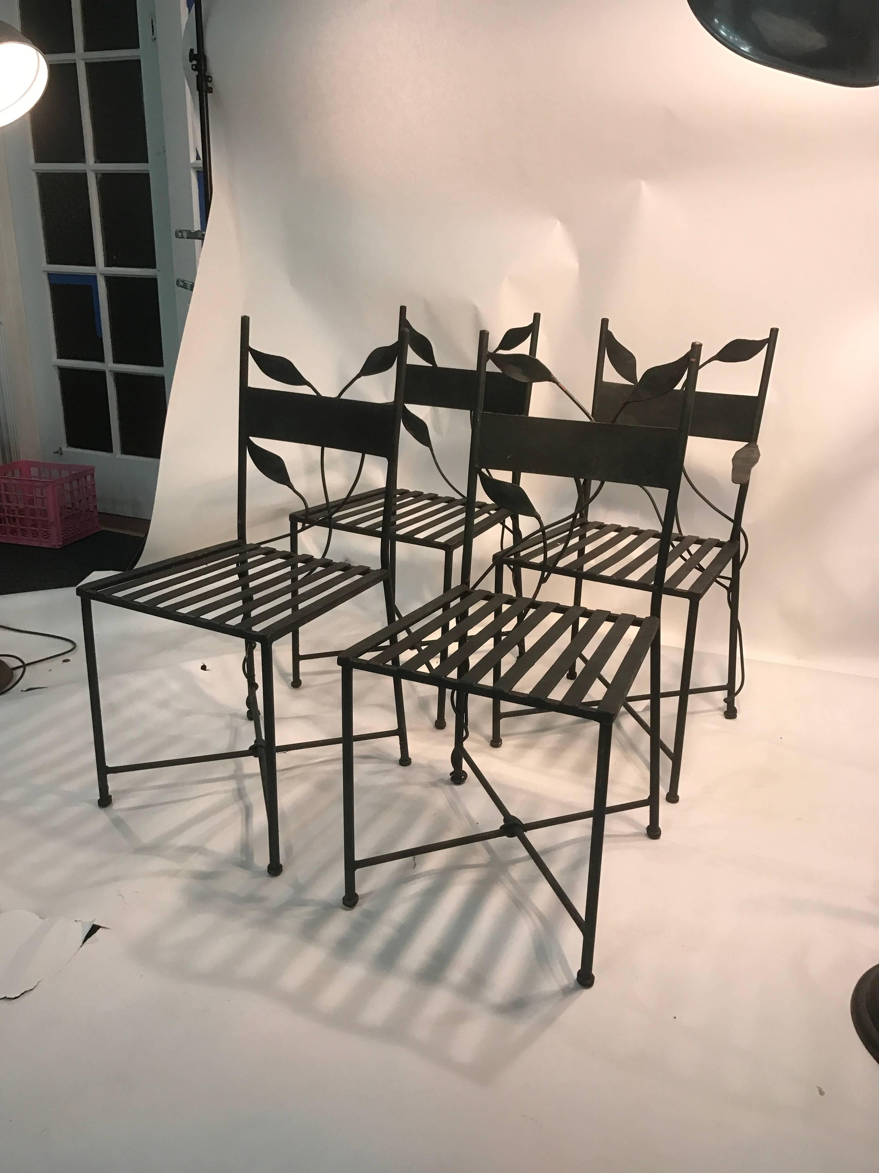 An outstanding set of four iron outdoor garden chairs with X-base and lovely leaf design in the manner of Claude Lalanne, circa 1970. Good vintage condition with age appropriate wear.
Dimensions: 
First pair: 35.5 H x 19 W x 20 D x 18 S
Second
