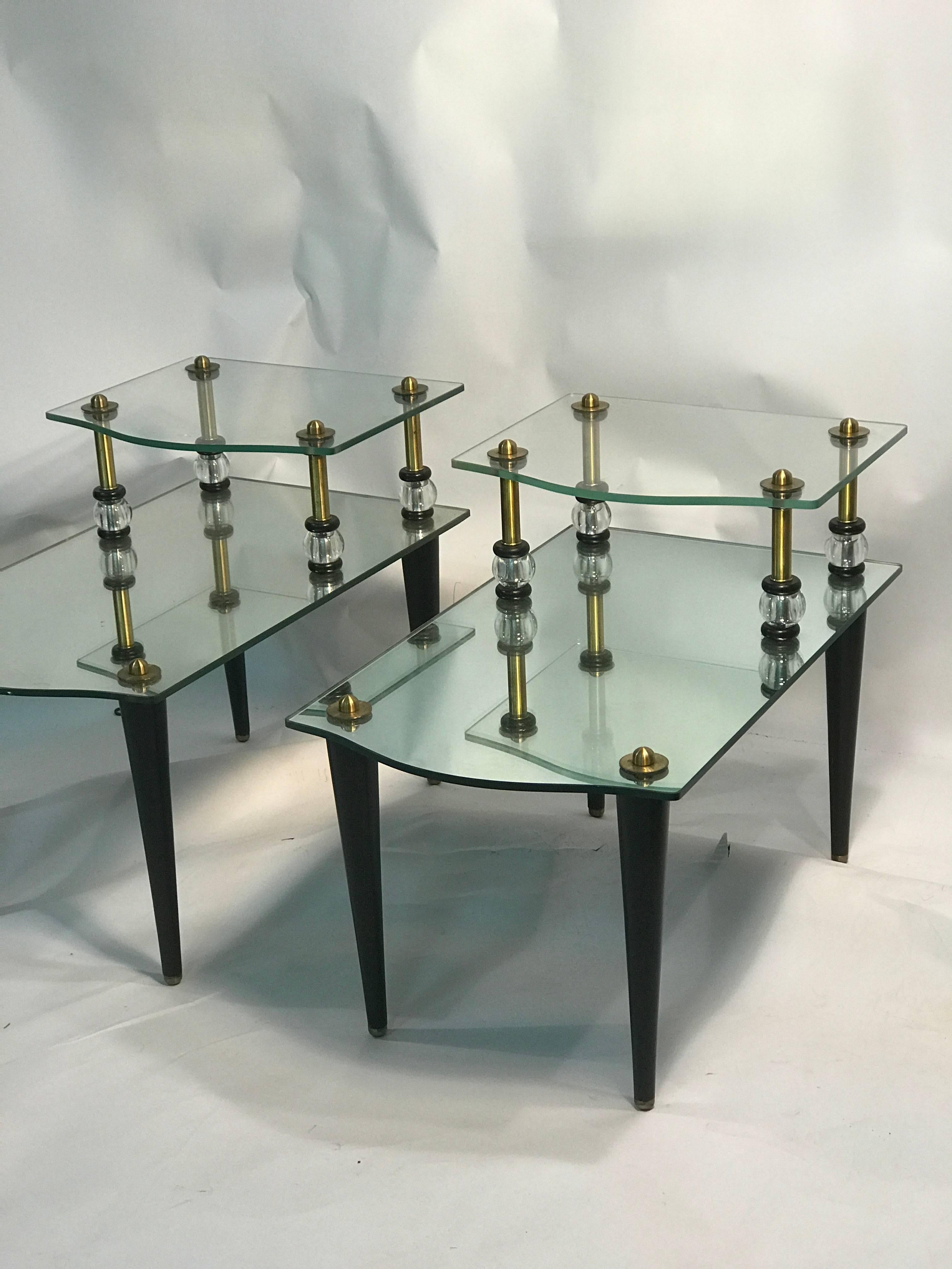 An exceptional pair of mirrored two-tier side, or end tables with brass accents, round Lucite balls with beautiful design, and tapered legs, circa 1970. Good vintage condition with age appropriate wear.

Top tier measures 23