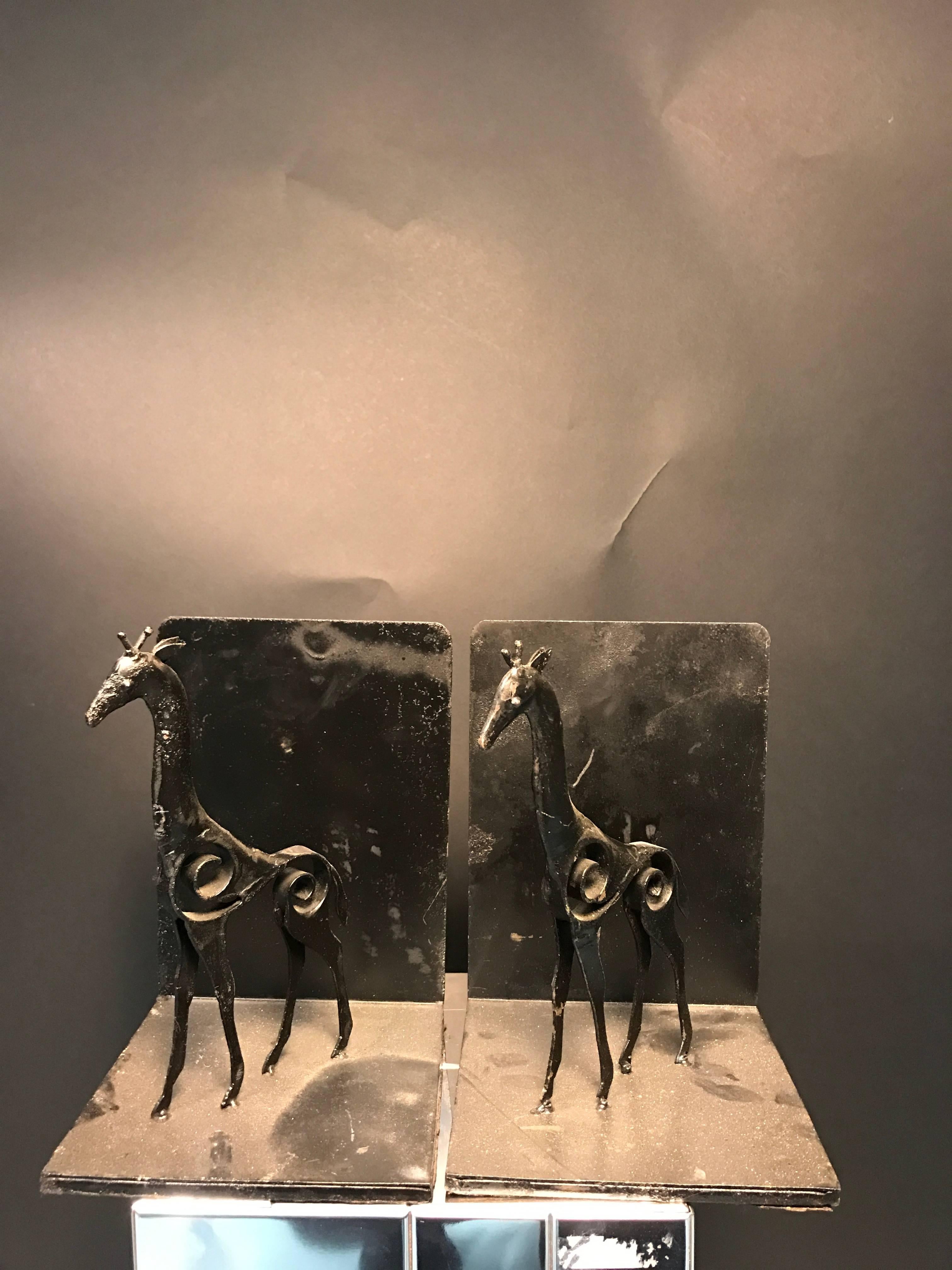 An unusual pair of painted iron bookends with beautiful sculptural giraffe in the manner of Giacometti, circa 1970. Good vintage condition with some wear appropriate with age.