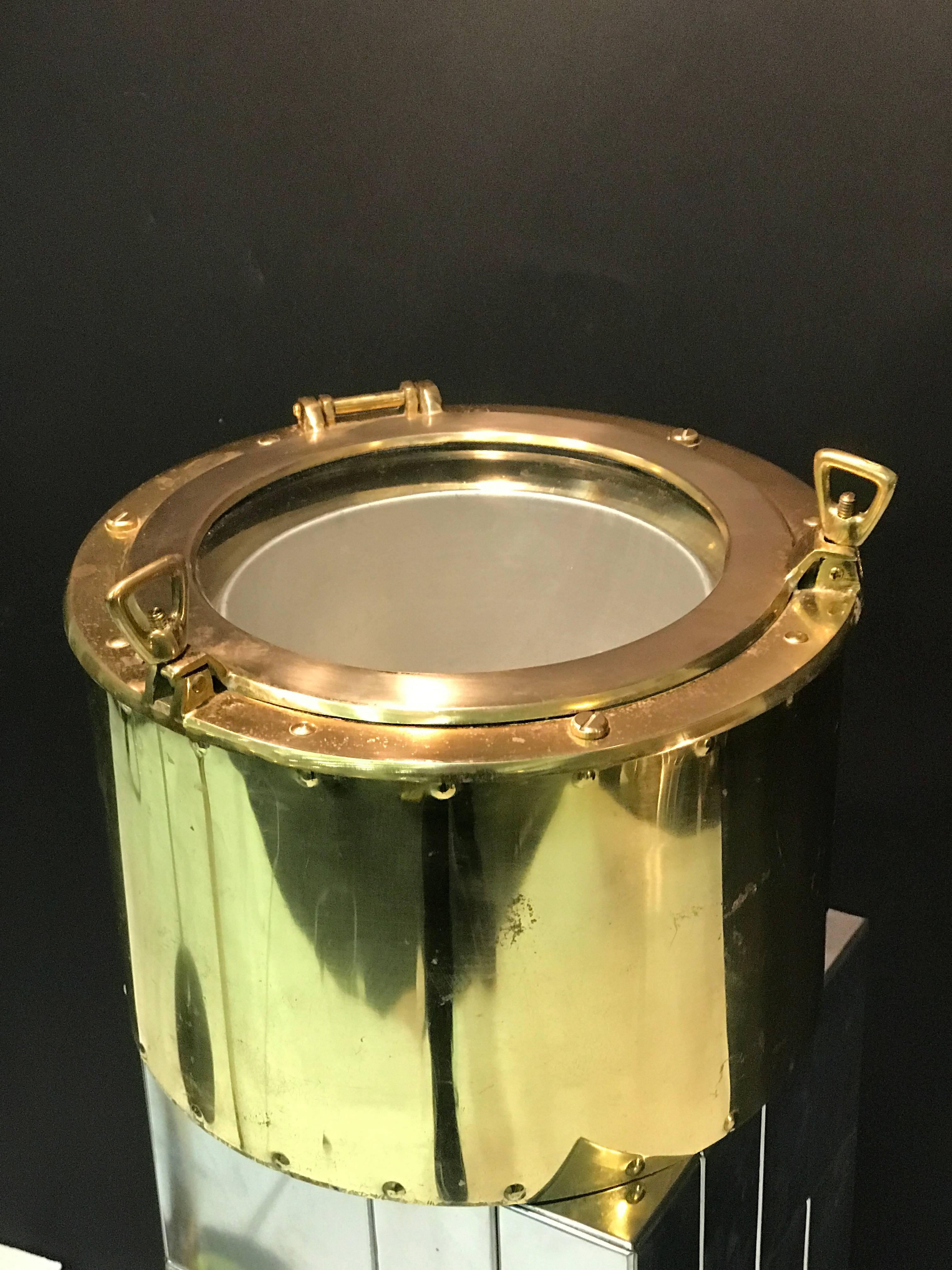 A rare yacht or boat themed brass porthole ice bucket, circa 1970. Great vintage condition with some wear appropriate with age.