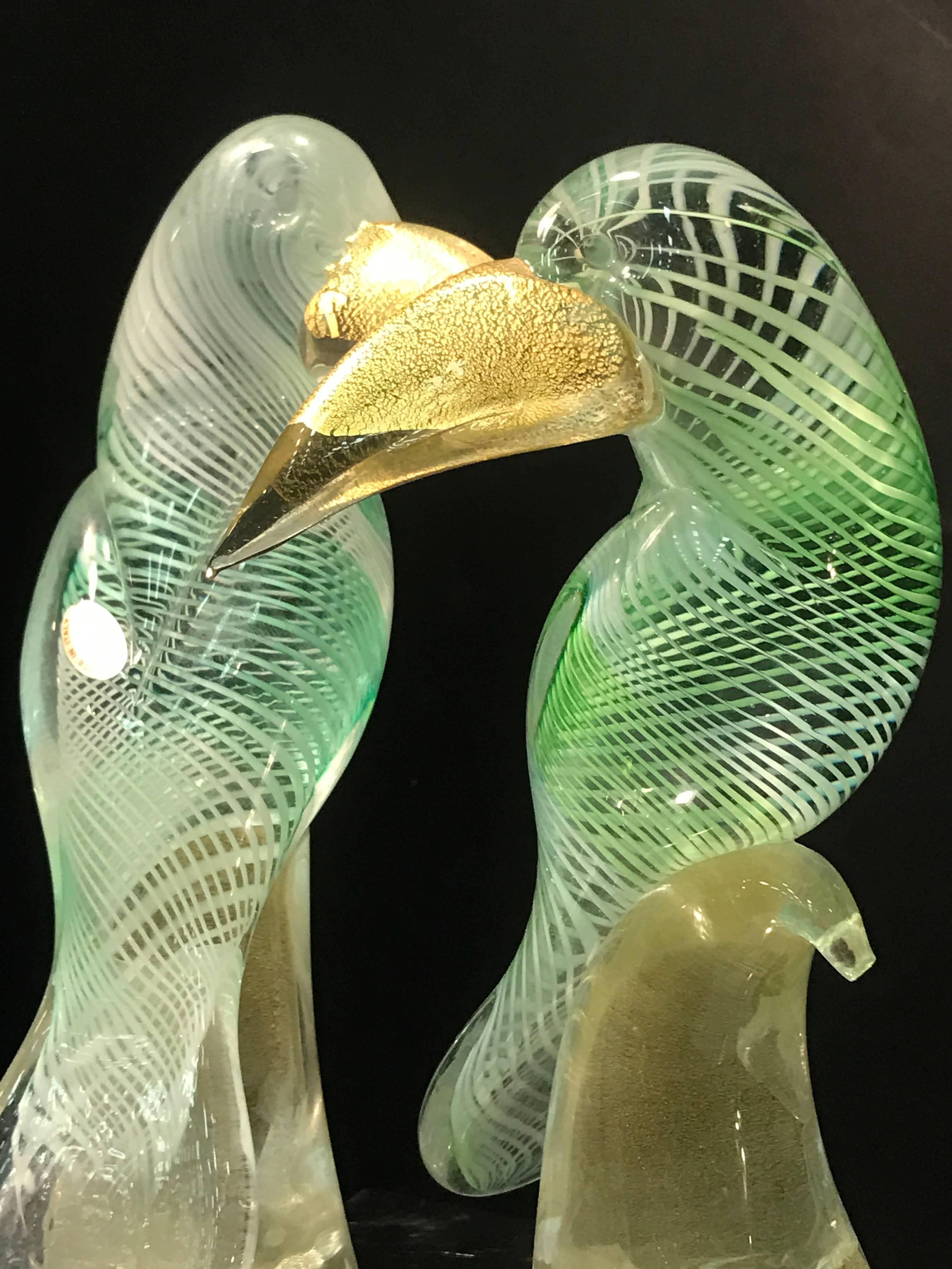 An amazing pair of Murano glass Archimede Seguso green and white latticino Toucans or birds with gold fleck beaks and perches. Great condition.