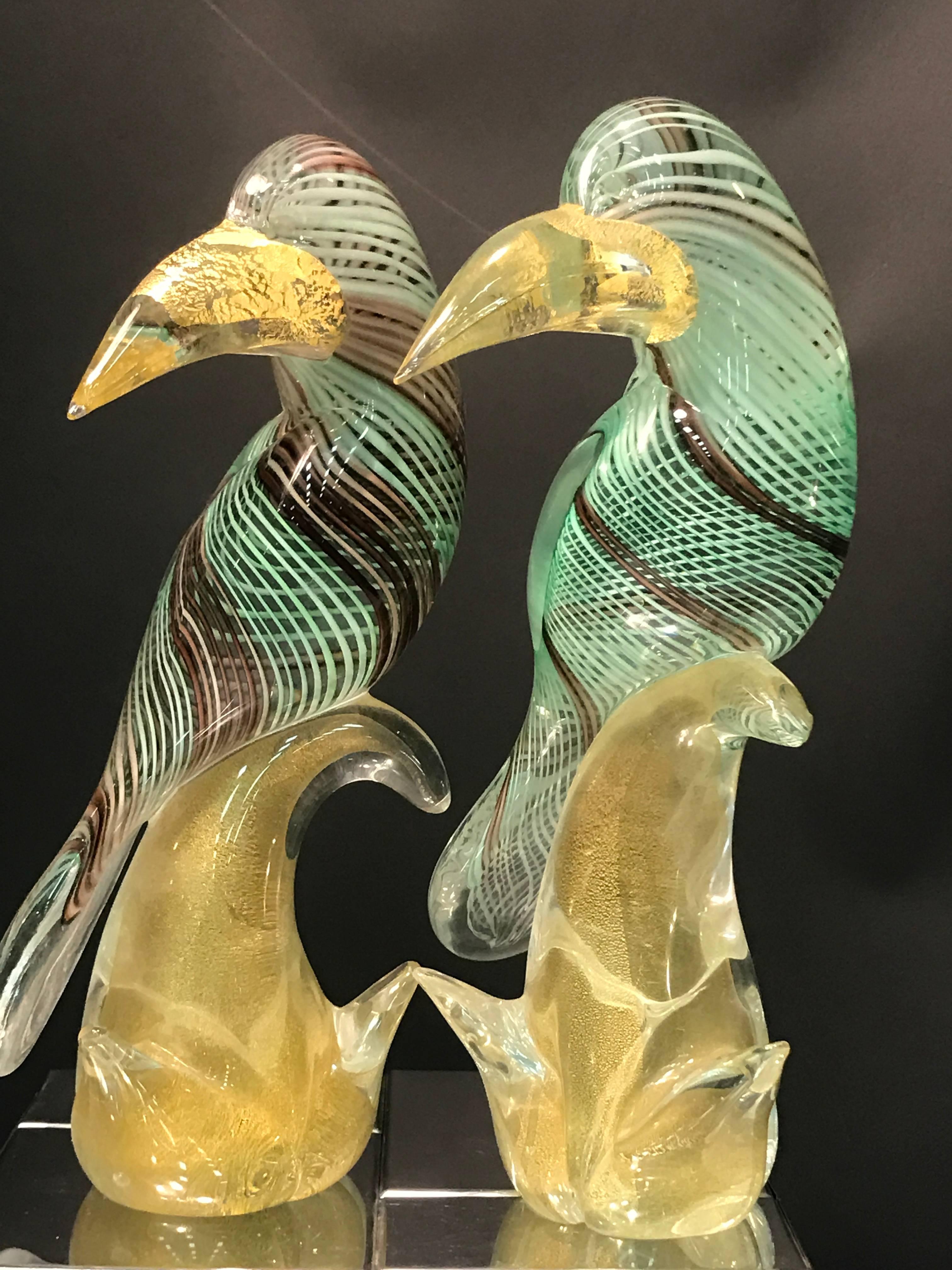 A stunning pair of Archimede Seguso Murano glass green toucans or birds with gold fleck beaks and perches, circa 1960. Great condition.