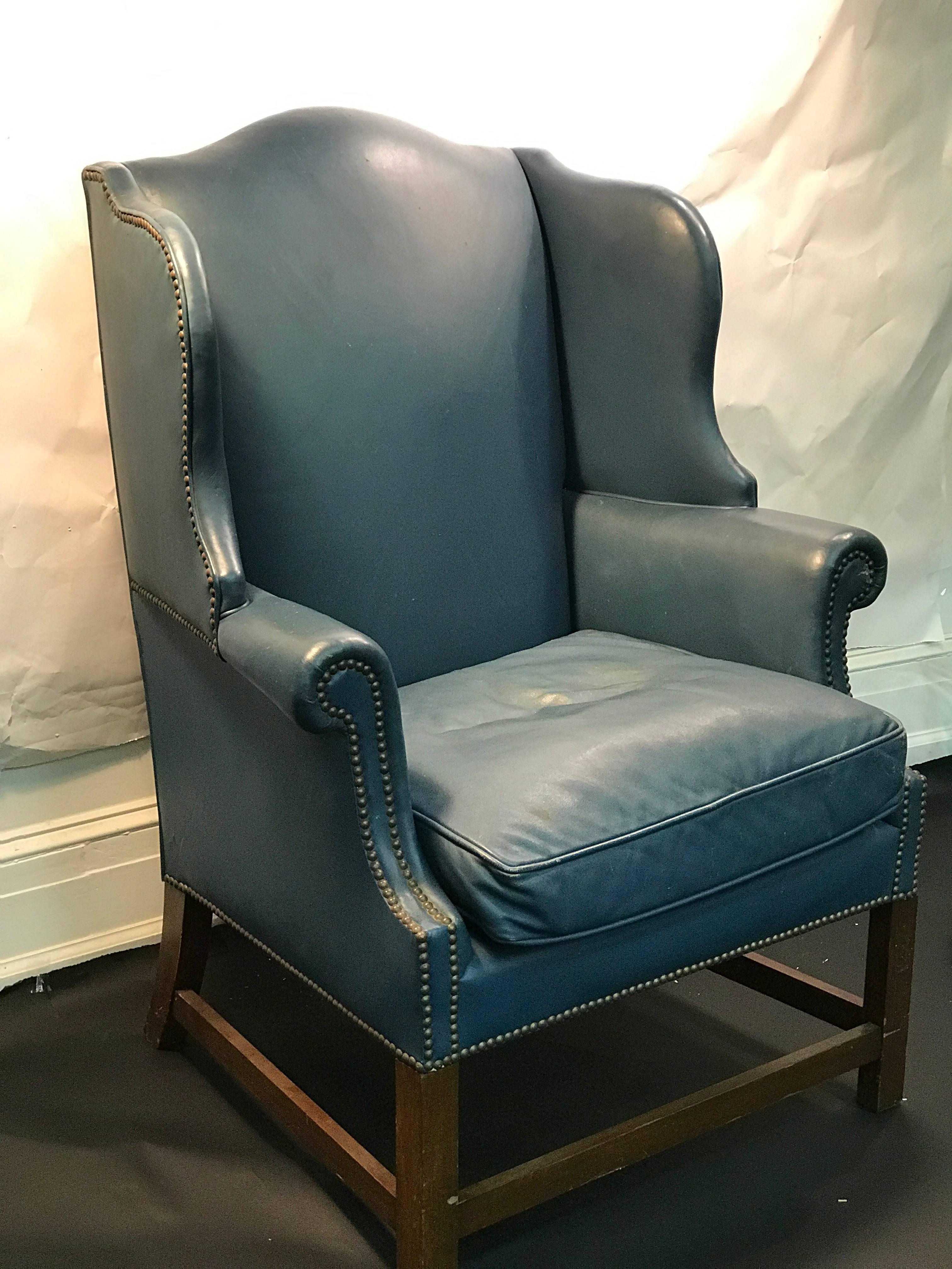A wonderful wingback chair with beautiful blue original leather upholstery and nailhead detail, circa 1960. Good vintage condition with age appropriate wear.