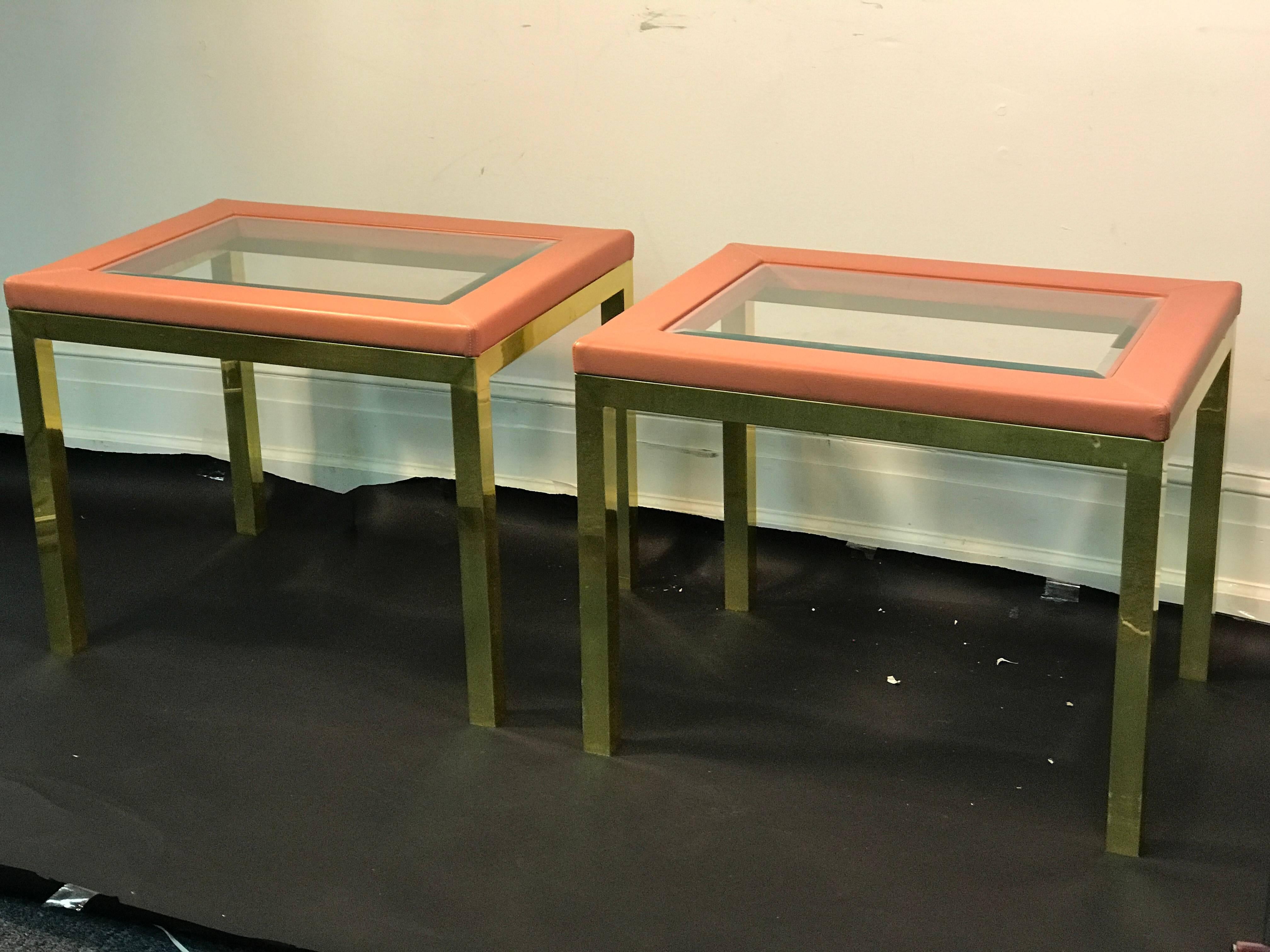 Incredible pair of Italian brass side tables with glass tops framed with beautiful pink leather in the manner of Karl Springer, circa 1980. Great condition.