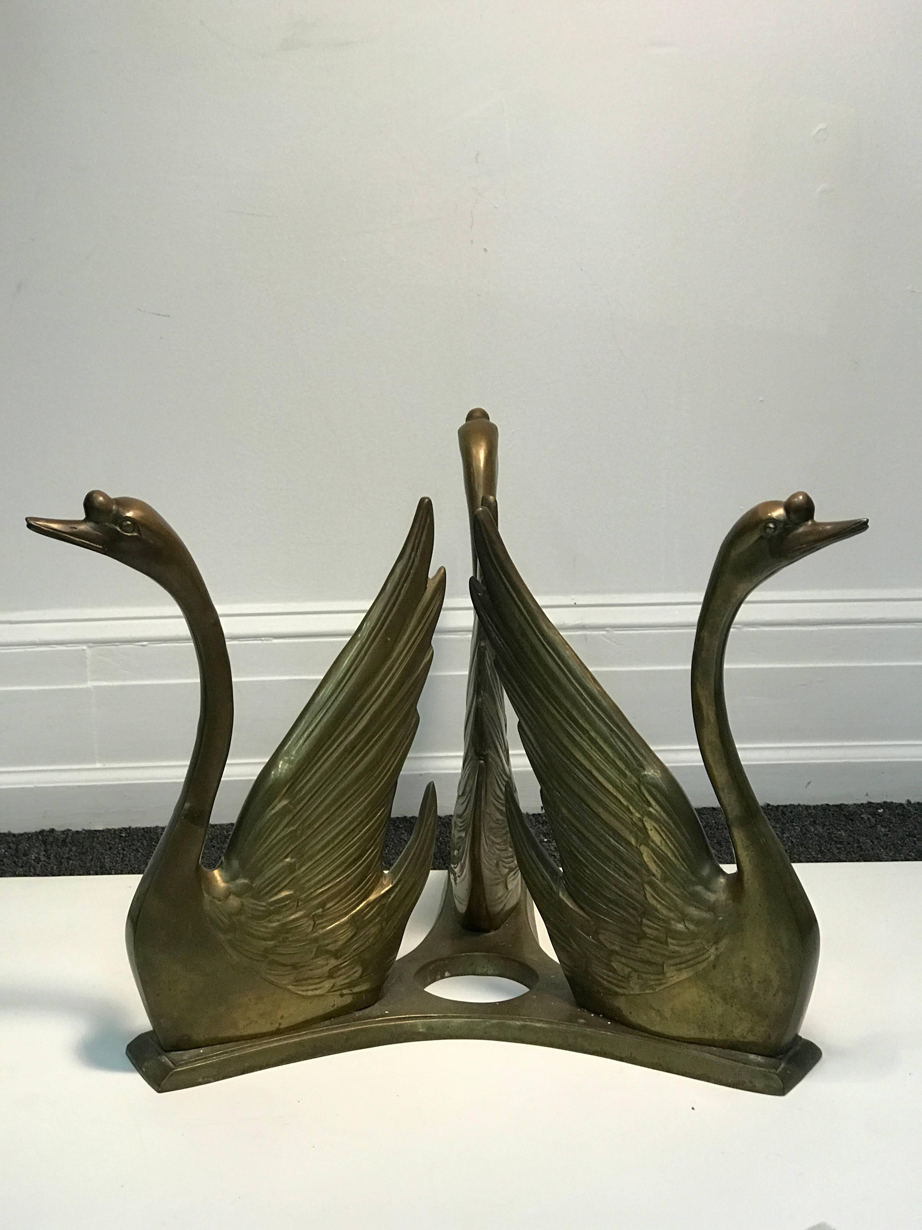 An exceptional coffee or cocktail table with base made of two beautiful, seated, sculptural brass swans in the style of Maison Jansen, circa 1970. Good vintage condition with some wear appropriate with age. The glass top measures 38