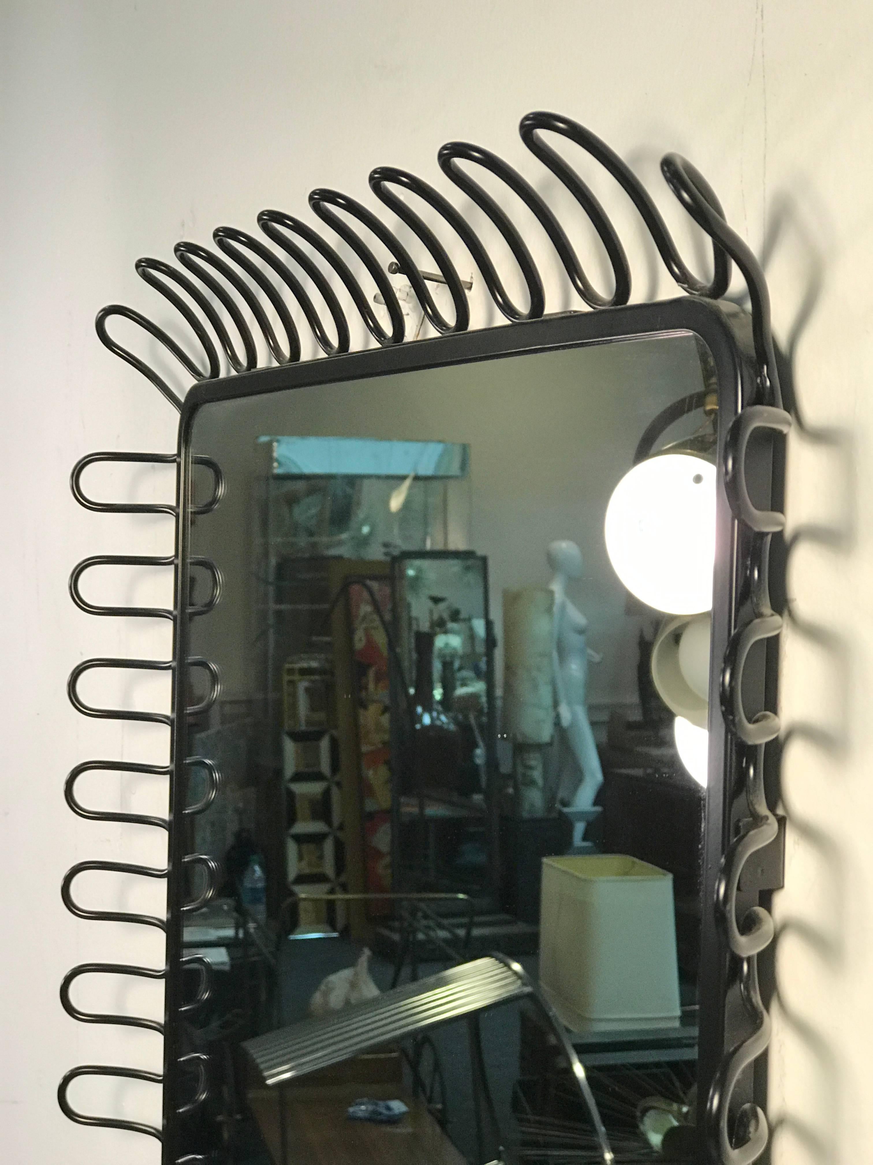 A beautiful modern mirror with unusual design in the manner of Jean Royere, circa 1980. Good condition.