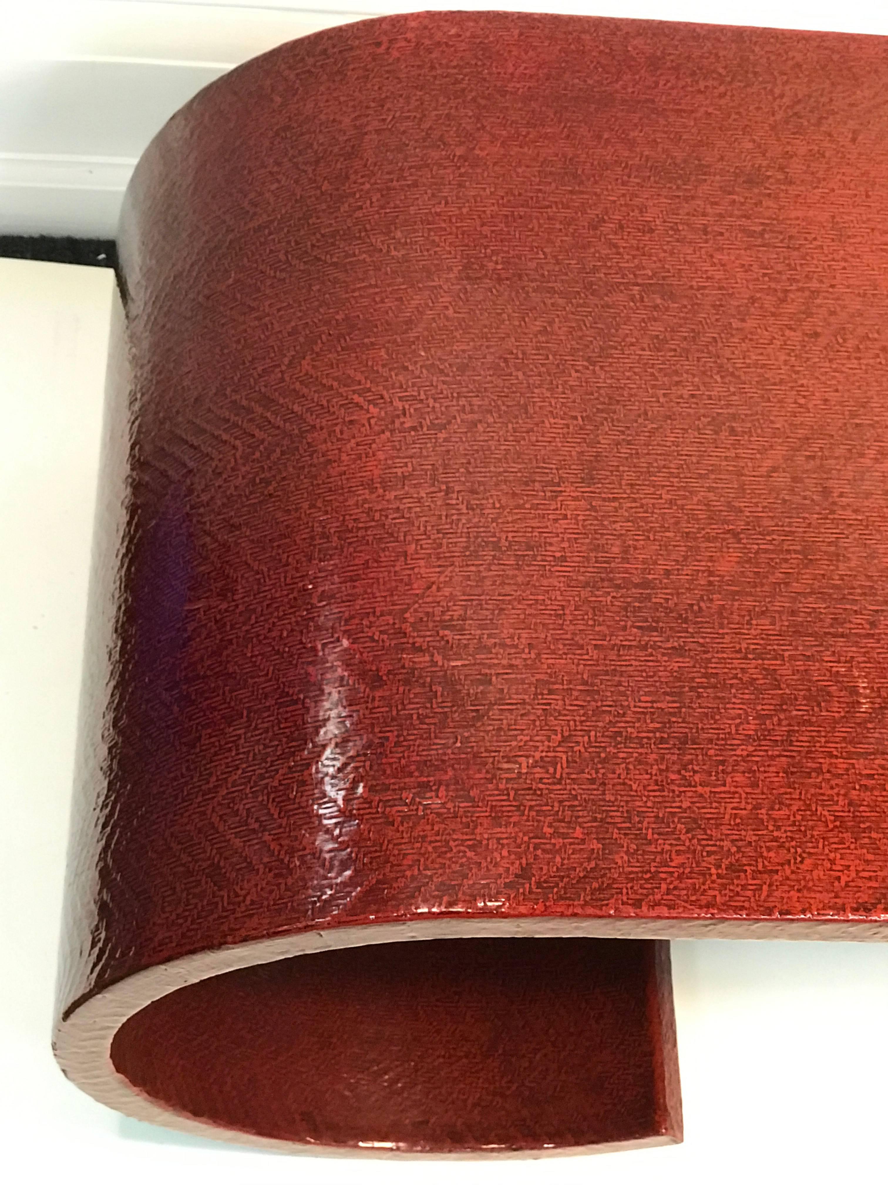 A stunning Karl Springer coffee or cocktail table wrapped completely in a fabulous textured animal-embossed linen. Beautiful burgundy color with lacquer finish, circa 1970. Good condition with some wear appropriate with age. Minor loss to lacquer in