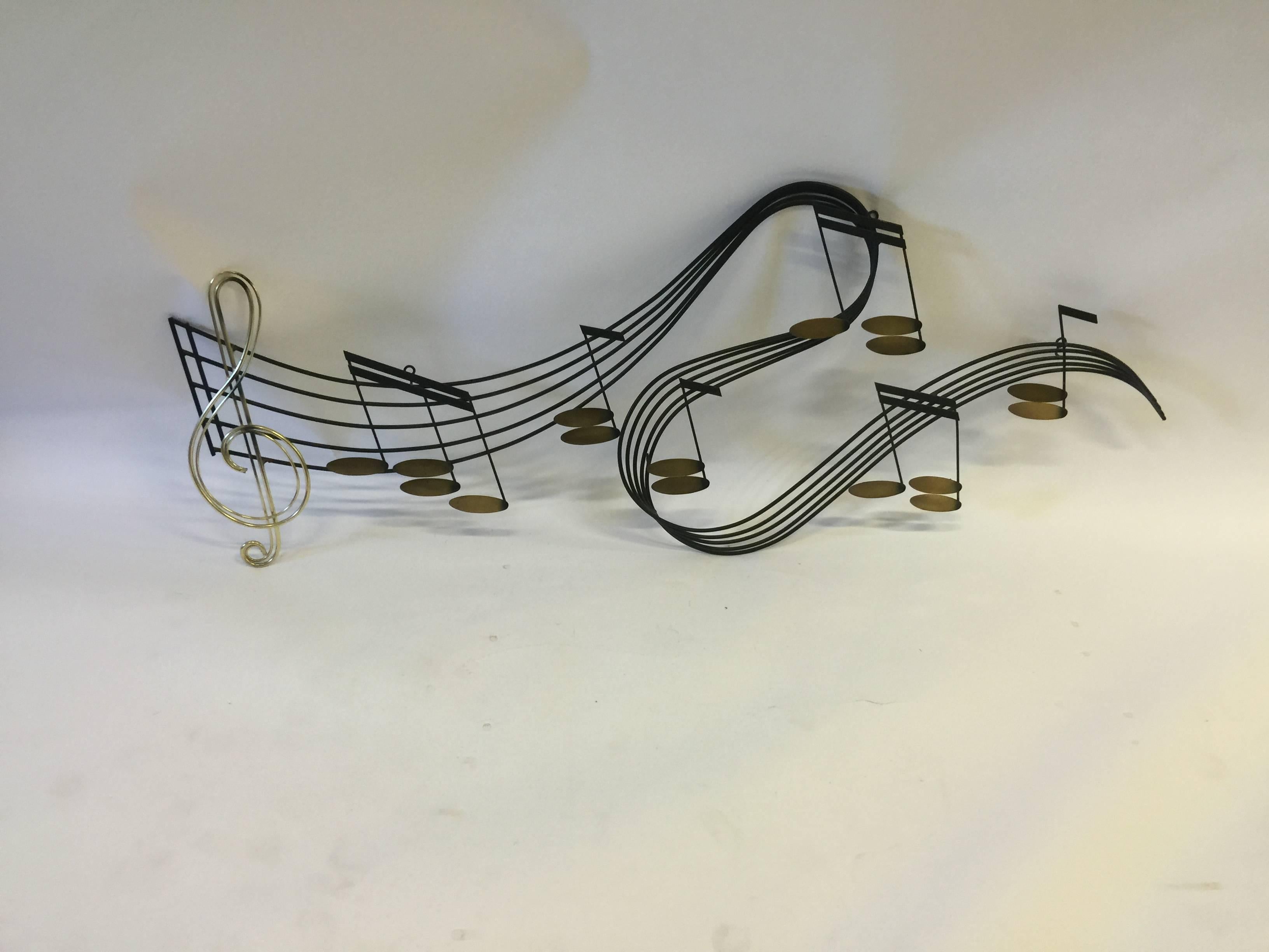Black enameled and polished brass musical score wall sculpture by Curtis Jere,
circa 1970s. A nice flowing wall hanging that would playfully accent many interiors.