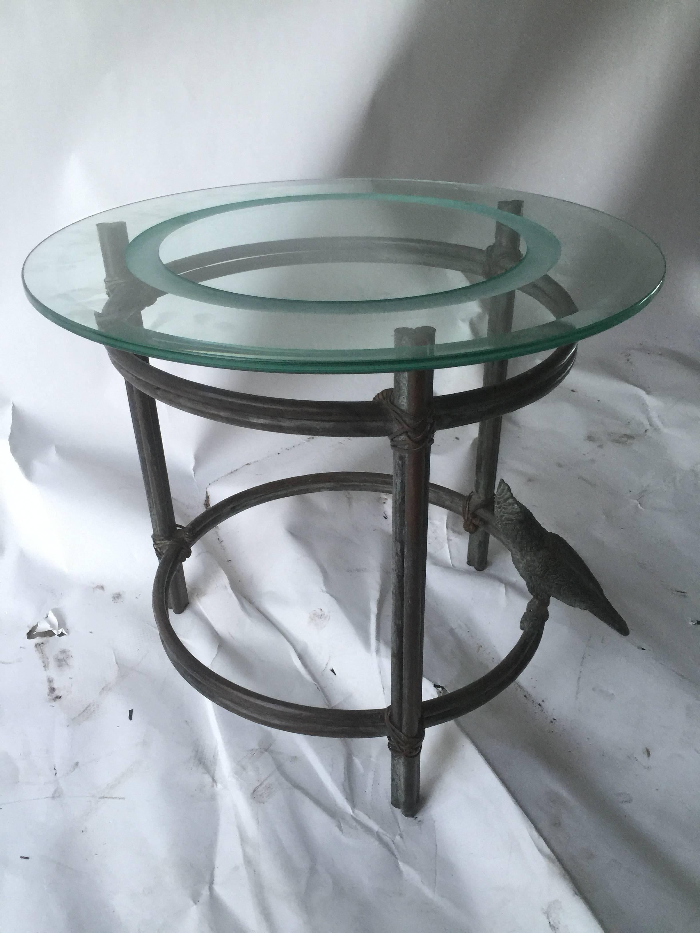 Interesting and well cast bronze accent table designed in a branch form with a cockatoo perched on one side. Having a nice beveled glass top with an etched circle design in the center. Done in the 1970s this is an organic and modernistic form