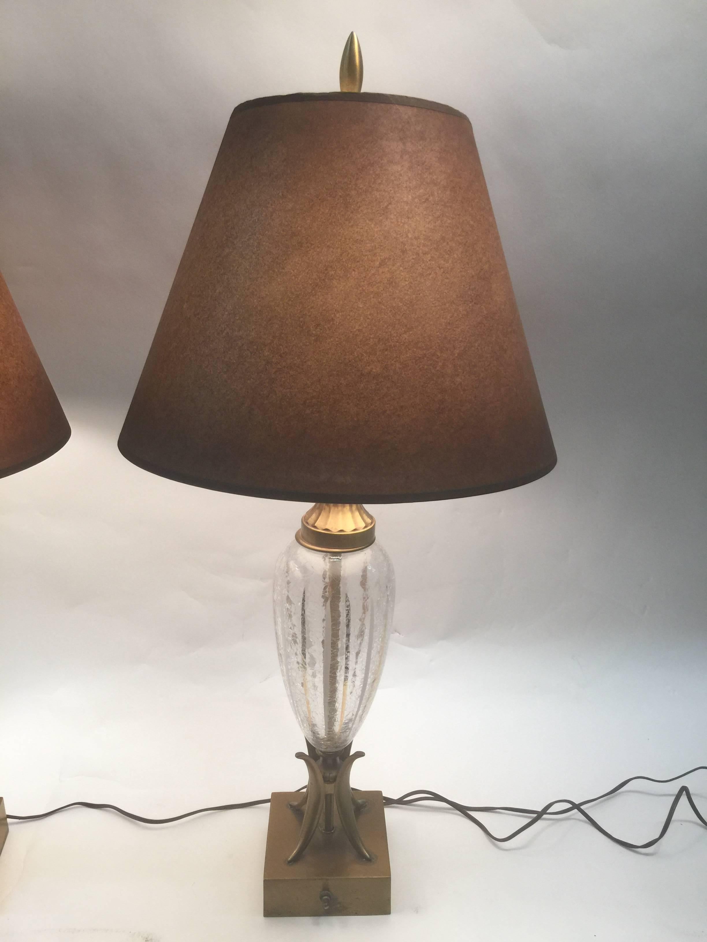 A great Mid-Century egg shaped clear crackle glass with gold and white striped design lamps with great Quality brass design bases and finials. A fine decorative pair of lamps perfect for many modern settings.