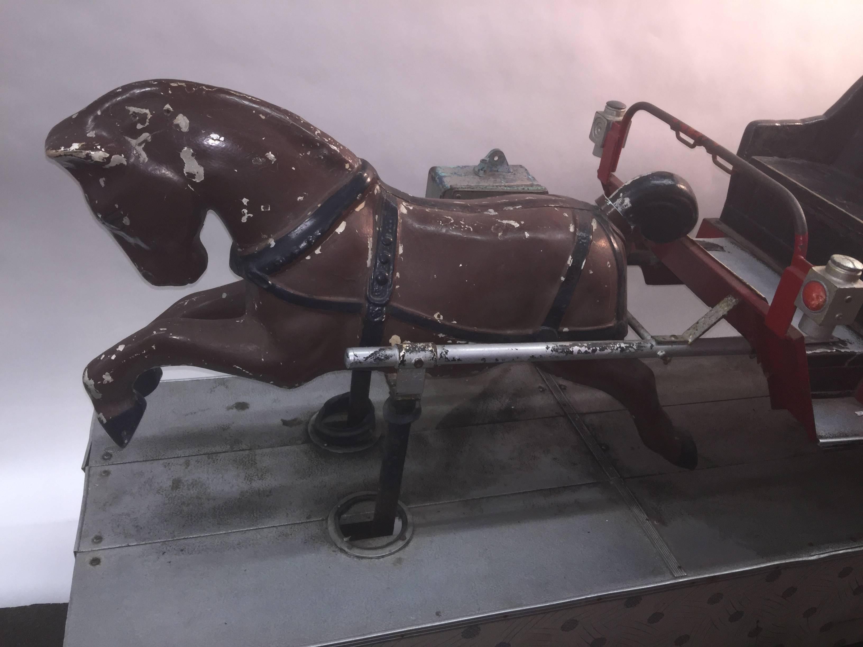 A really cool automated ride circa 1940s-1960s depicting a horse pulling a seated carriage with a water tank attached that firemen used back in the Day. Working and operational, meaning you can take a ride on the undulating seat, this can be viewed
