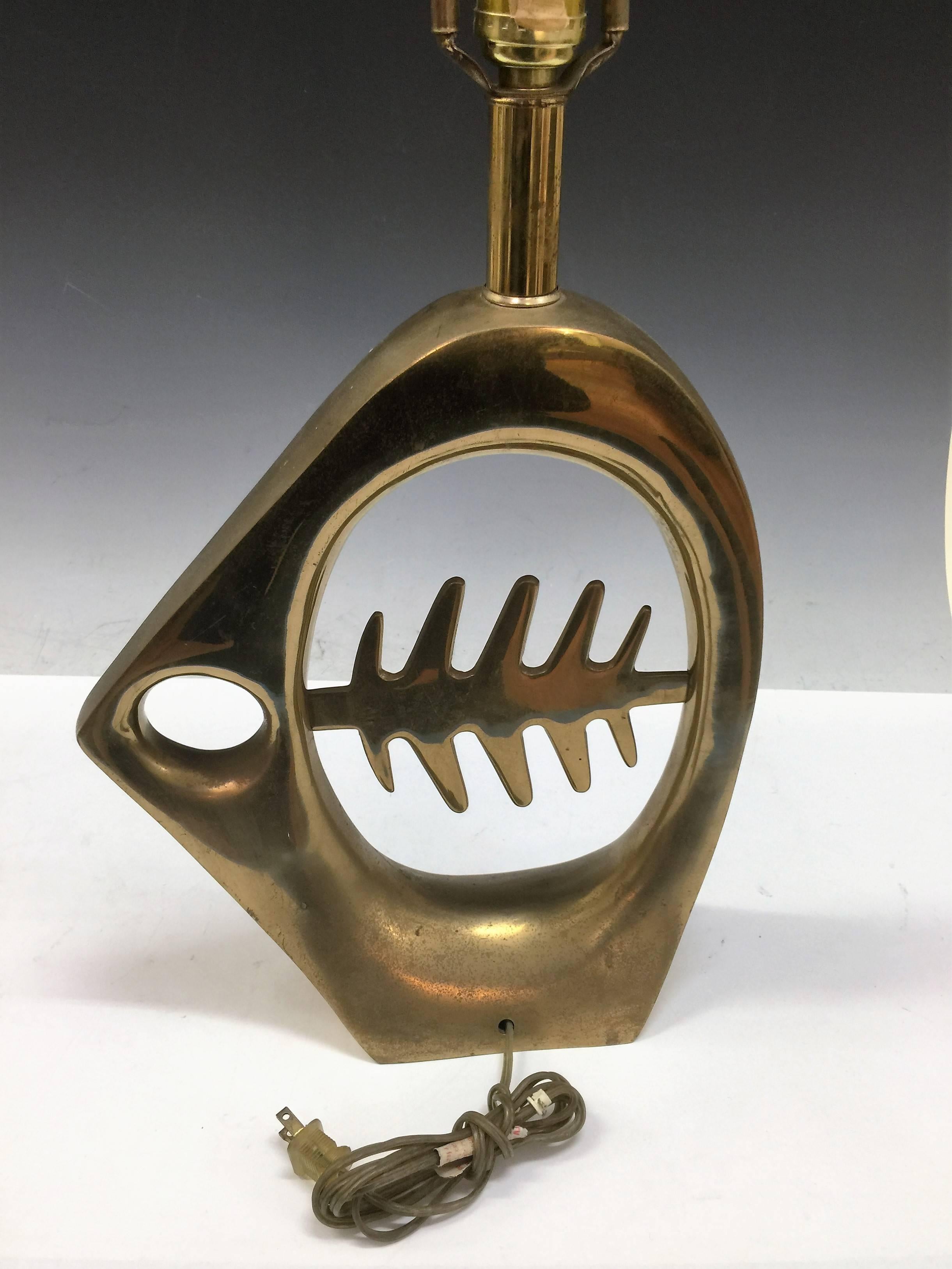 Really cool sculptural brass X-ray fish lamp with exaggerated bones inside body. Great masterful design. Perfect accent lamp that is both functional and a great sculpture as well. The measurement of the fish body alone is 14