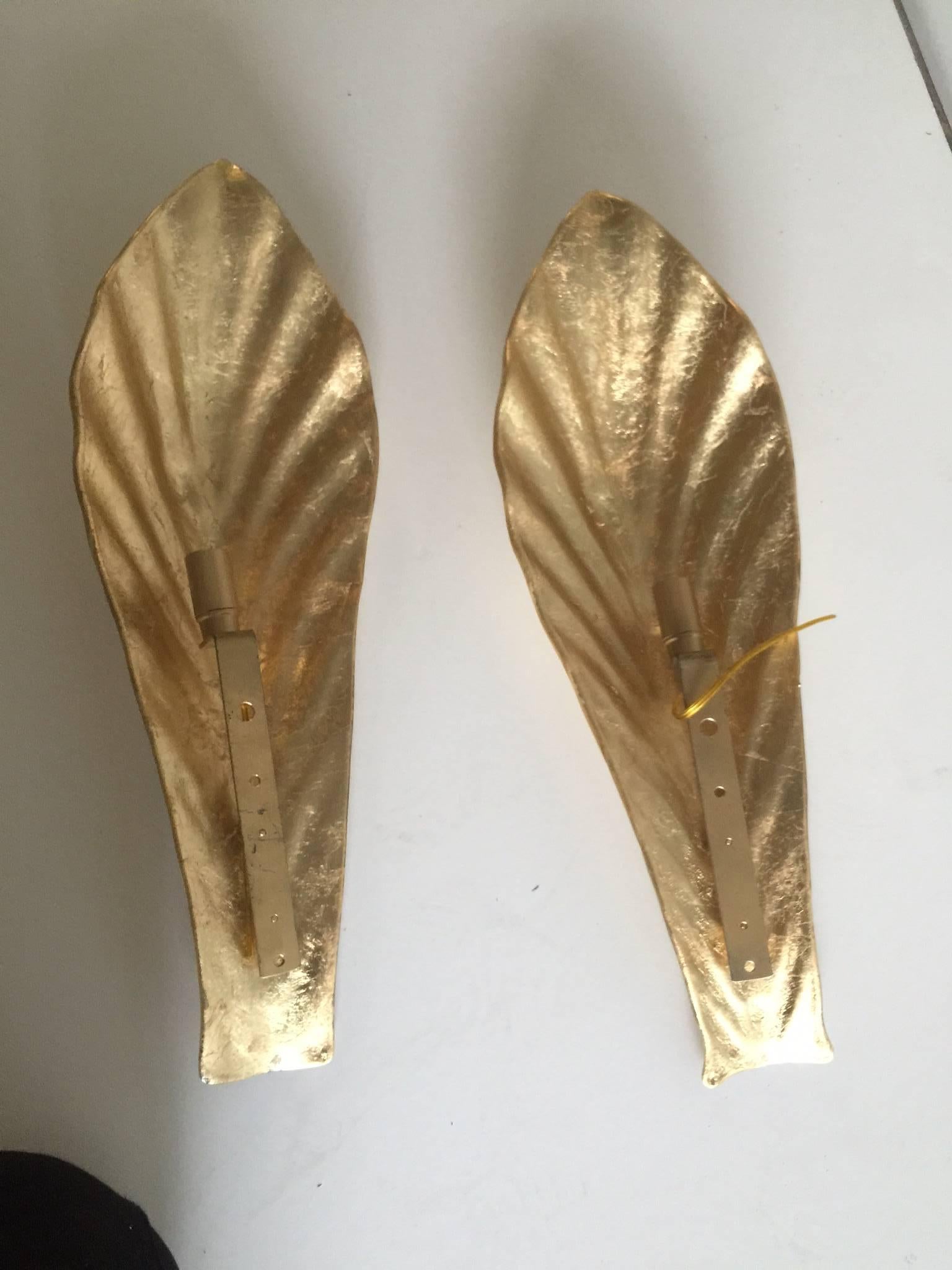 A vintage pair of Italian golden color Murano glass leaf sconces. There is a second pair of sconces available for purchase separately.