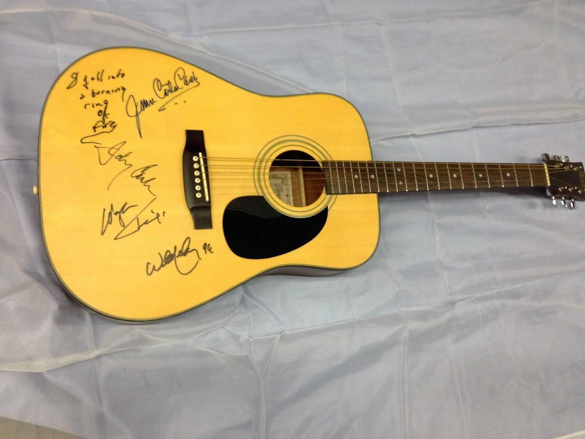 This guitar is autographed by Johnny Cash, June Carter Cash. Waylon Jennings and Willie Nelson. Johnny Cash inscribed 'I Fell Into A Burning Ring Of Fire'. All Autographs were obtained in person by the seller, circa 1994. This guitar is an Ibanez