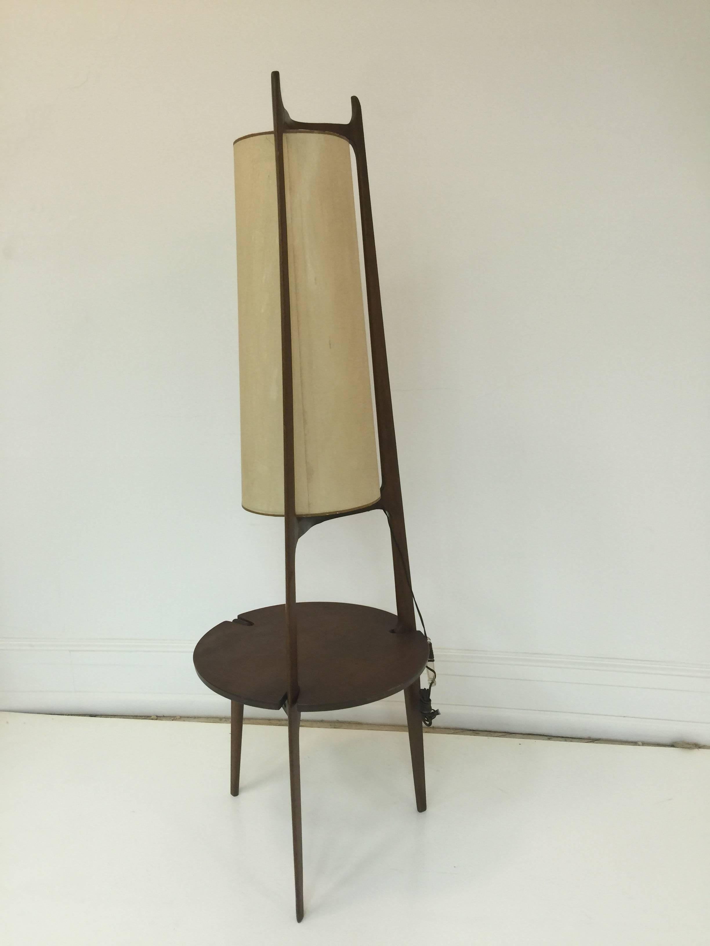 A Scandinavian modern lamp table or floor lamp in teak with tripod base, circa 1960s.

Overall height is 66