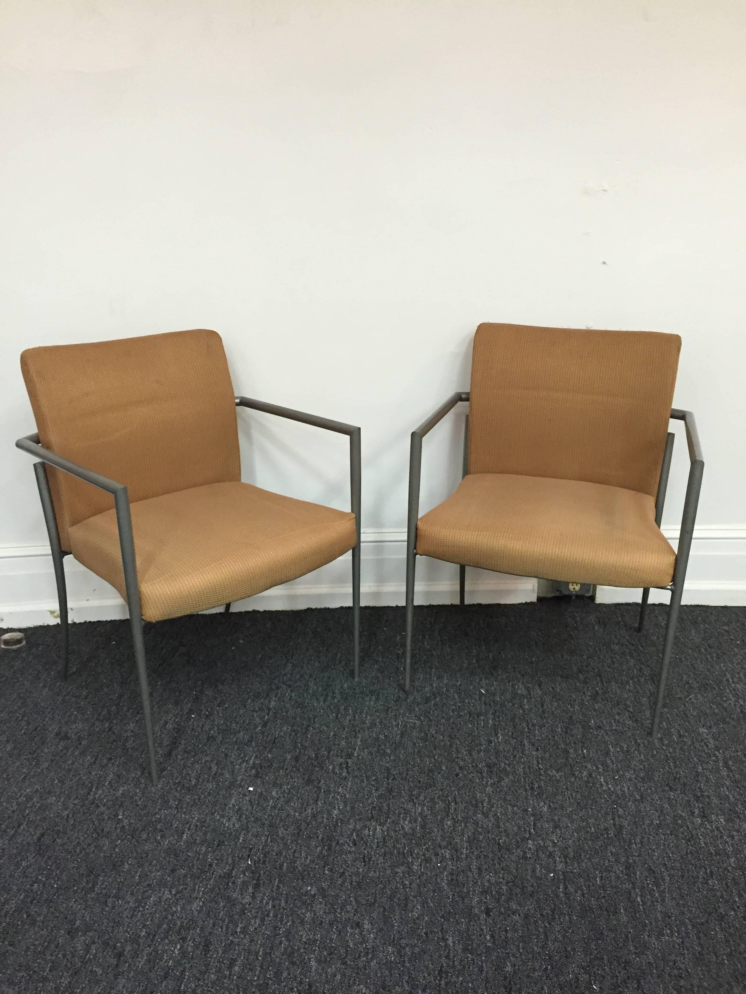 A pair Italian Gio Ponti style chairs with sleek design and tapered legs.