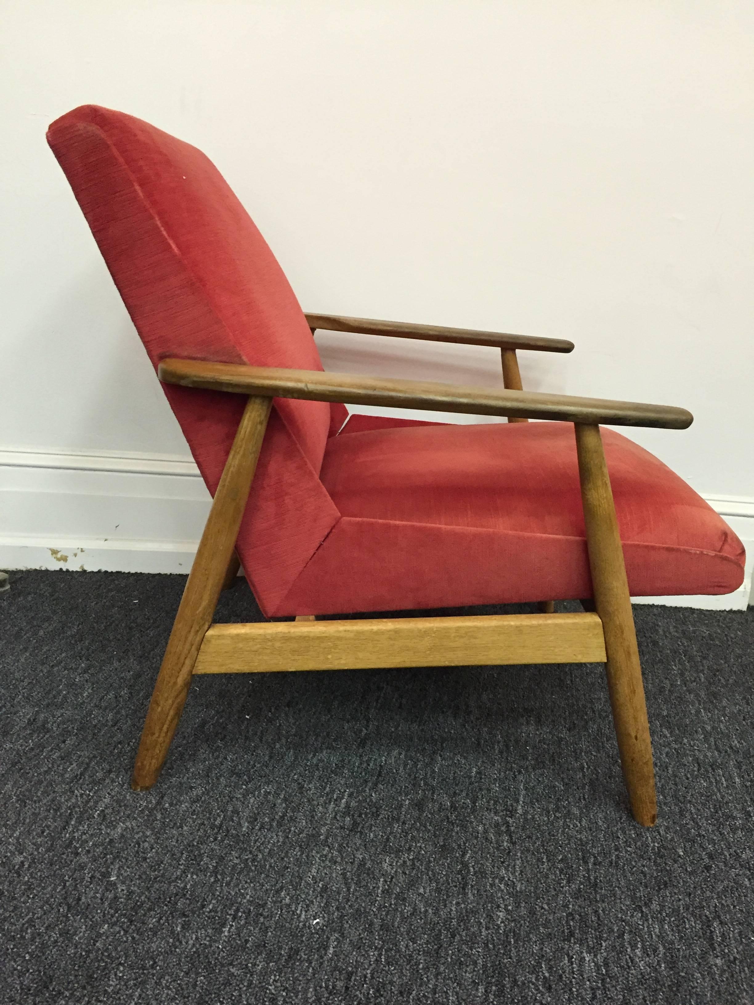 A pair of Scandinavian modern armchairs or lounge chairs in teak with original red upholstery, circa 1960.