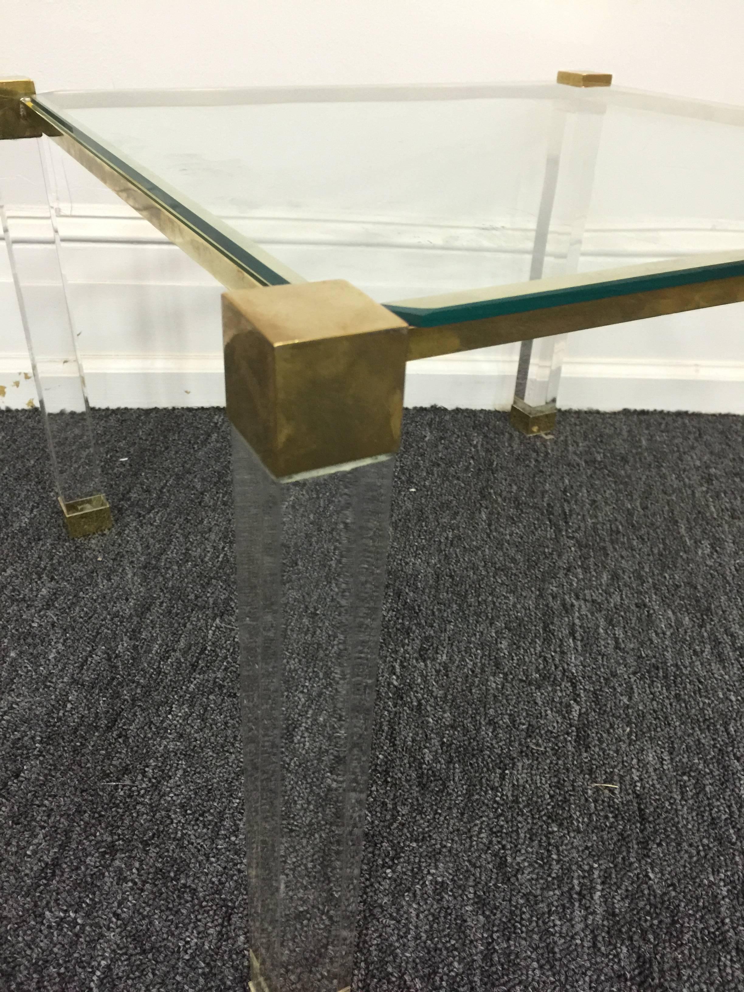 A pair of geometric form Charles Hollis Jones end or side tables with Lucite frames accented by brass corners and feet. Great high end tables perfect for your Modern interior.
     