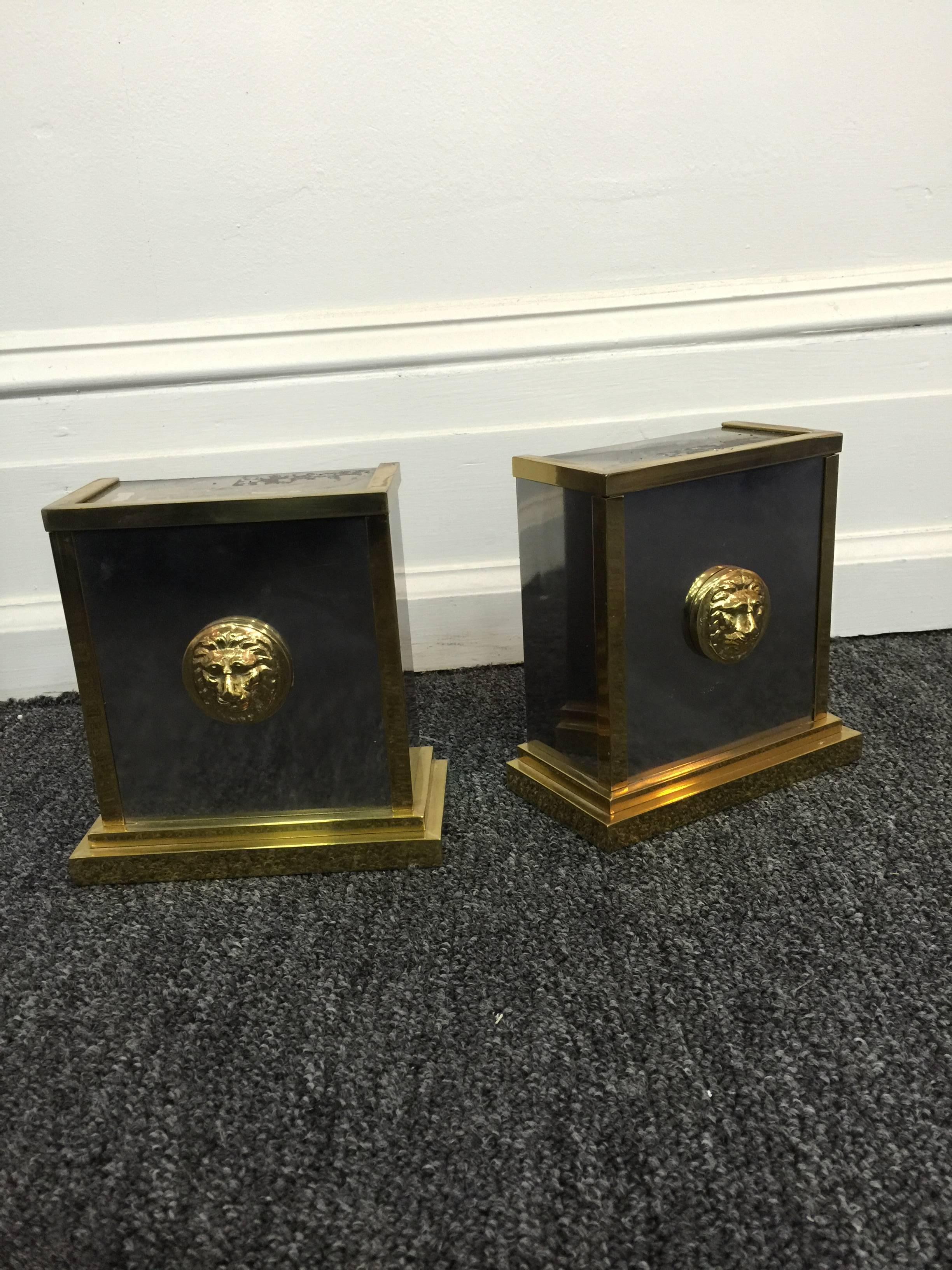 A pair of two-tone bookends with lion heads in the style of Versace, circa 1960.