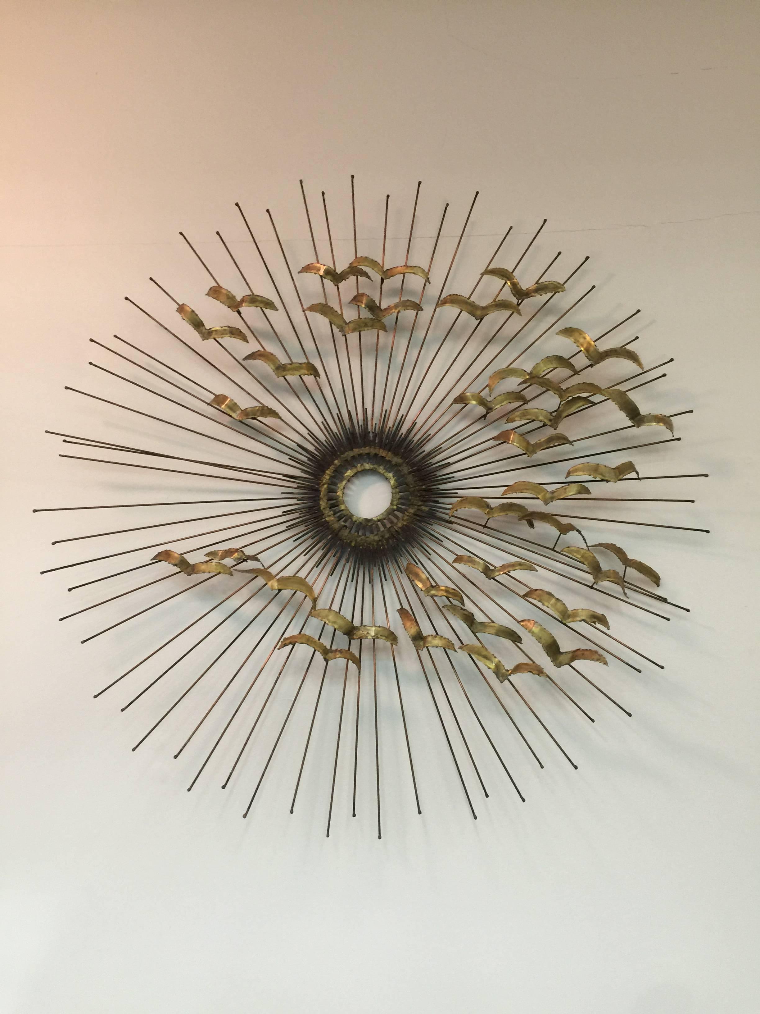 A Curtis Jere brass and copper wall sculpture with geese in flight, or sunburst with birds, circa 1970.