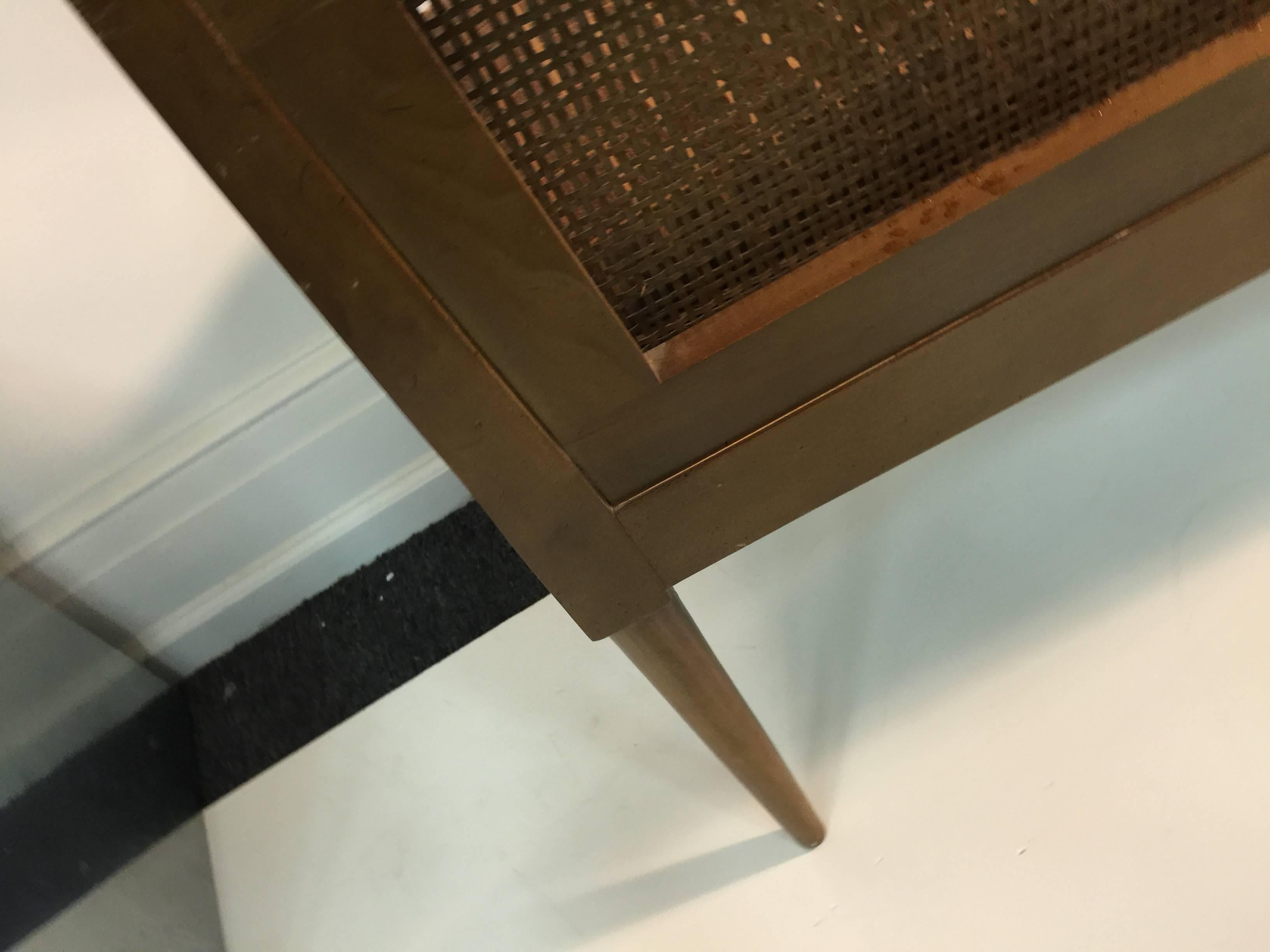 A Scandinavian Modern Dunbar style decorator cane window bench with great lines and tapered legs.
