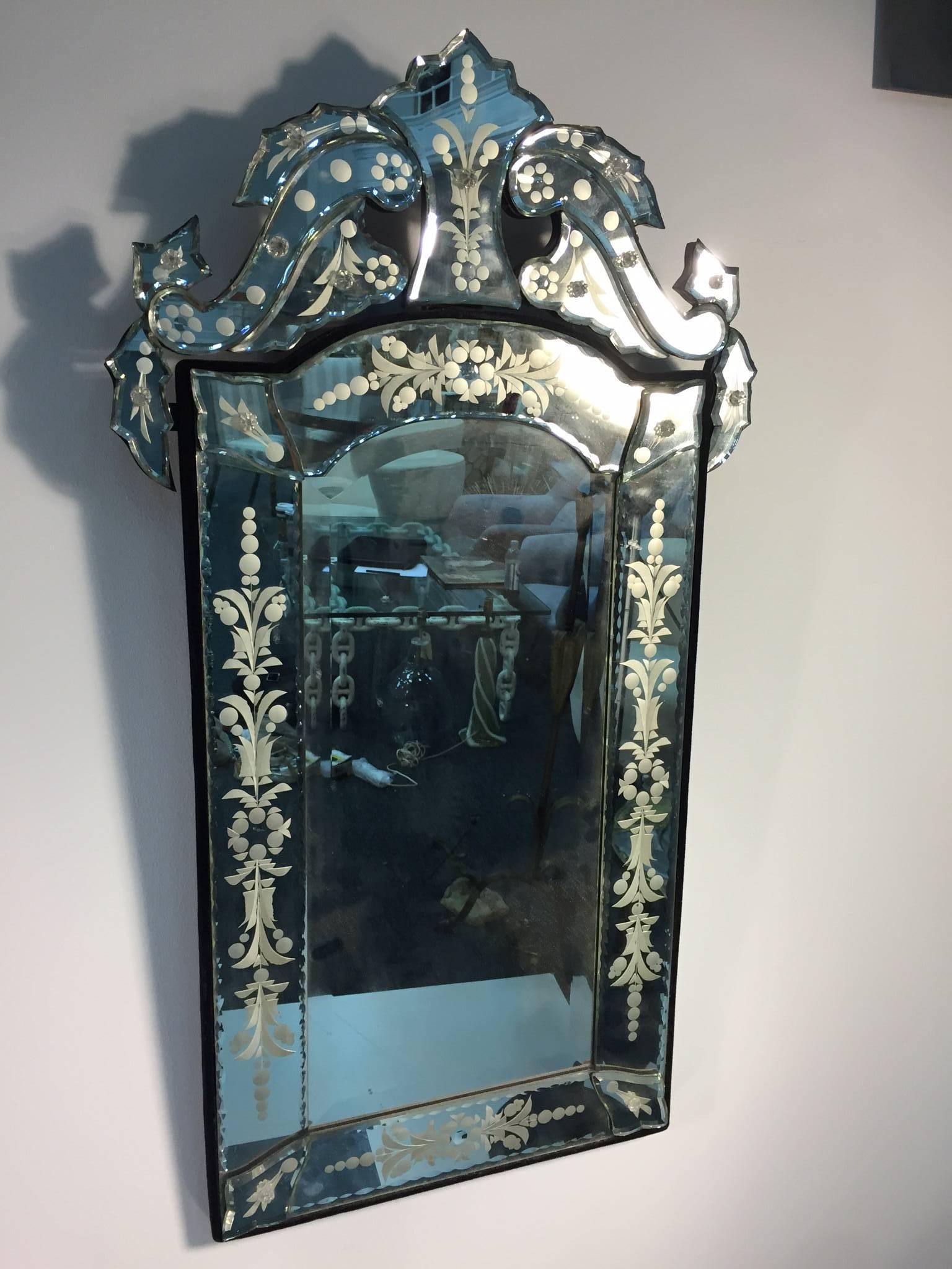 A beautiful cut-glass and etched Venetian mirror with floral and leaf motif.