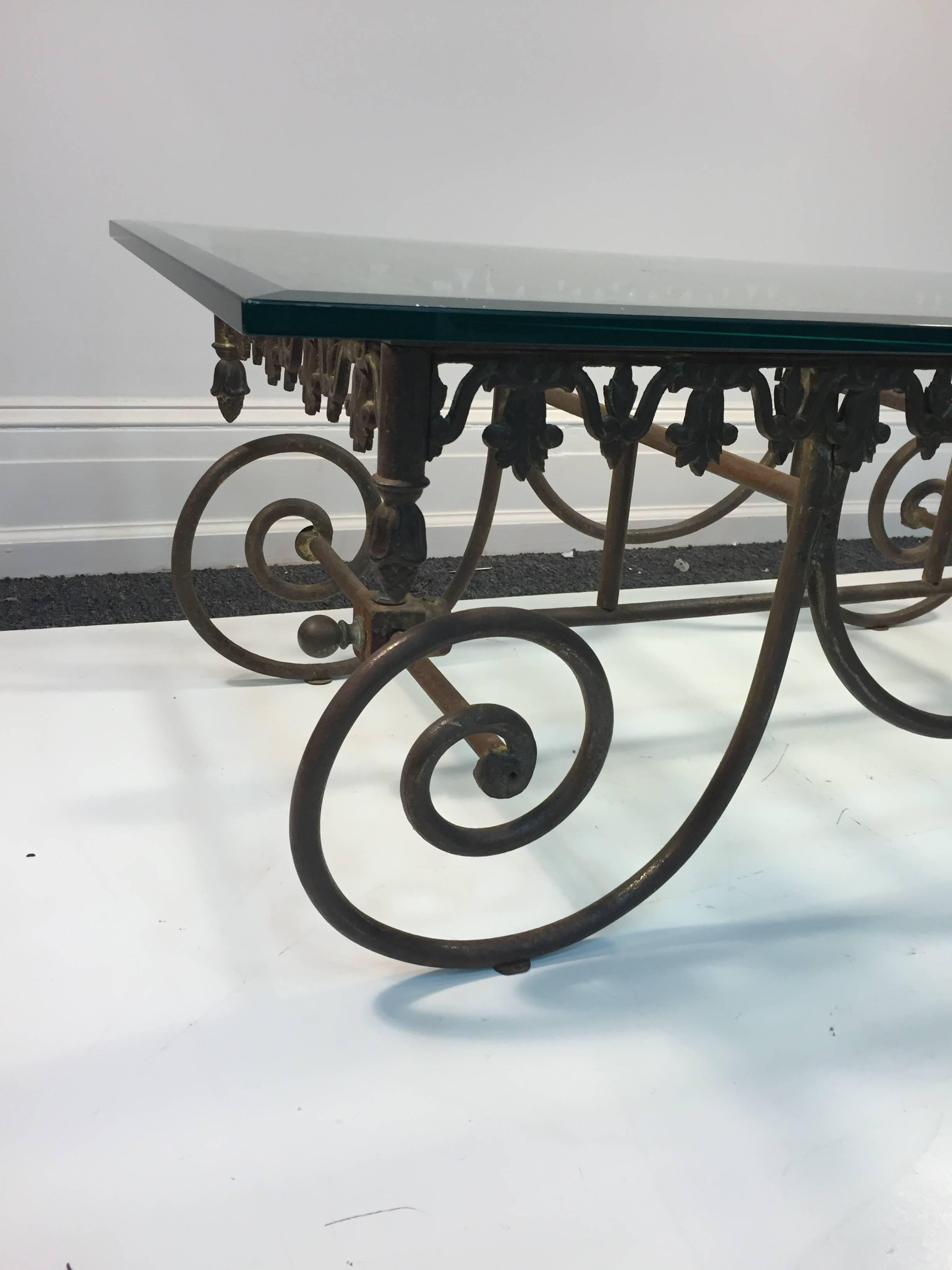 An exceptional 19th century wrought iron French Bakers table with scrolled frame and 3/4