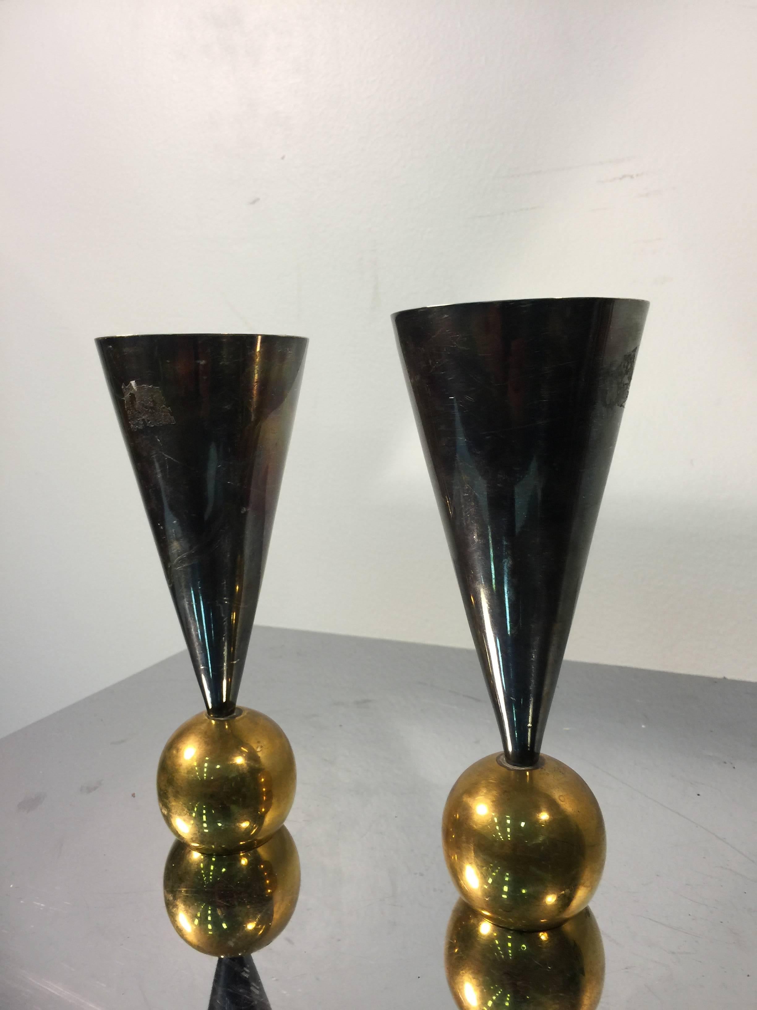 A spectacular solid brass pair of cone and ball form candlesticks in the manner of Gio Ponti, circa 1970.