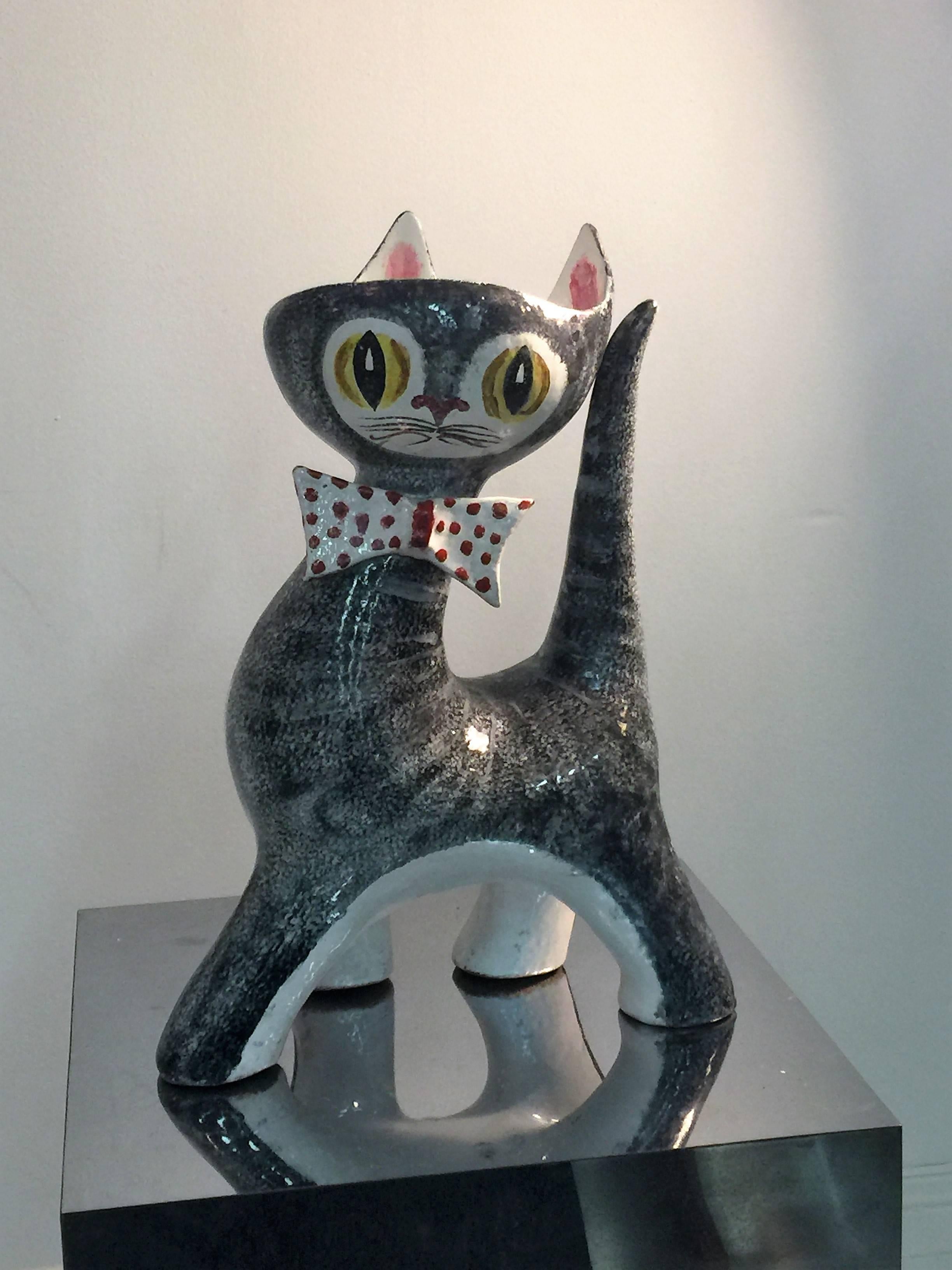 Adorable 1950s ceramic cat figure/vase made in Italy, hand-painted with a sweet expression and polka dot bowtie. This great cat would be perfect in any feline loving interior. Signed Italy under the foot.