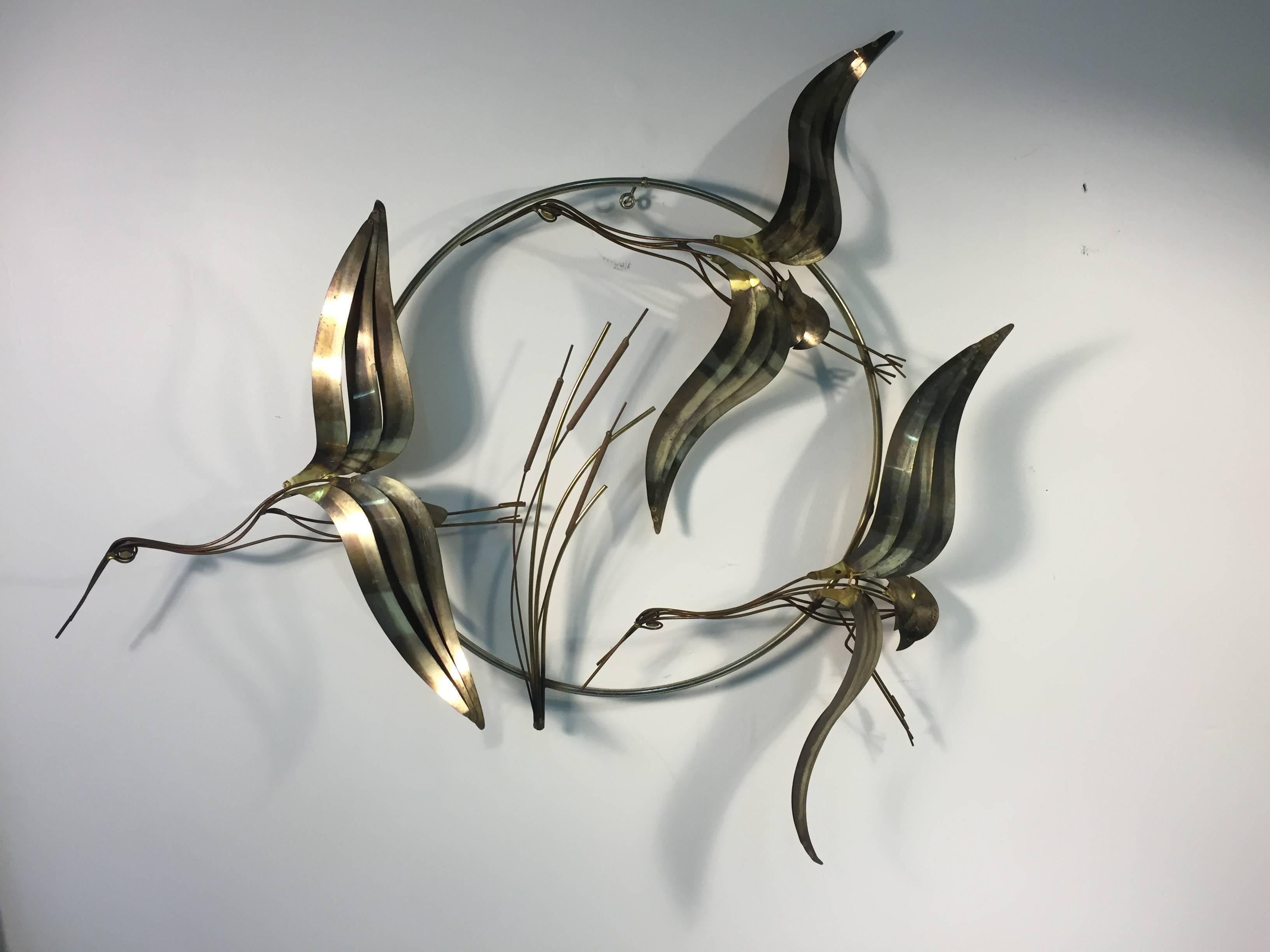 A beautiful Curtis Jere wall sculpture with three herons ad cattails signed C Jere, 1983. Good vintage condition with age appropriate wear.