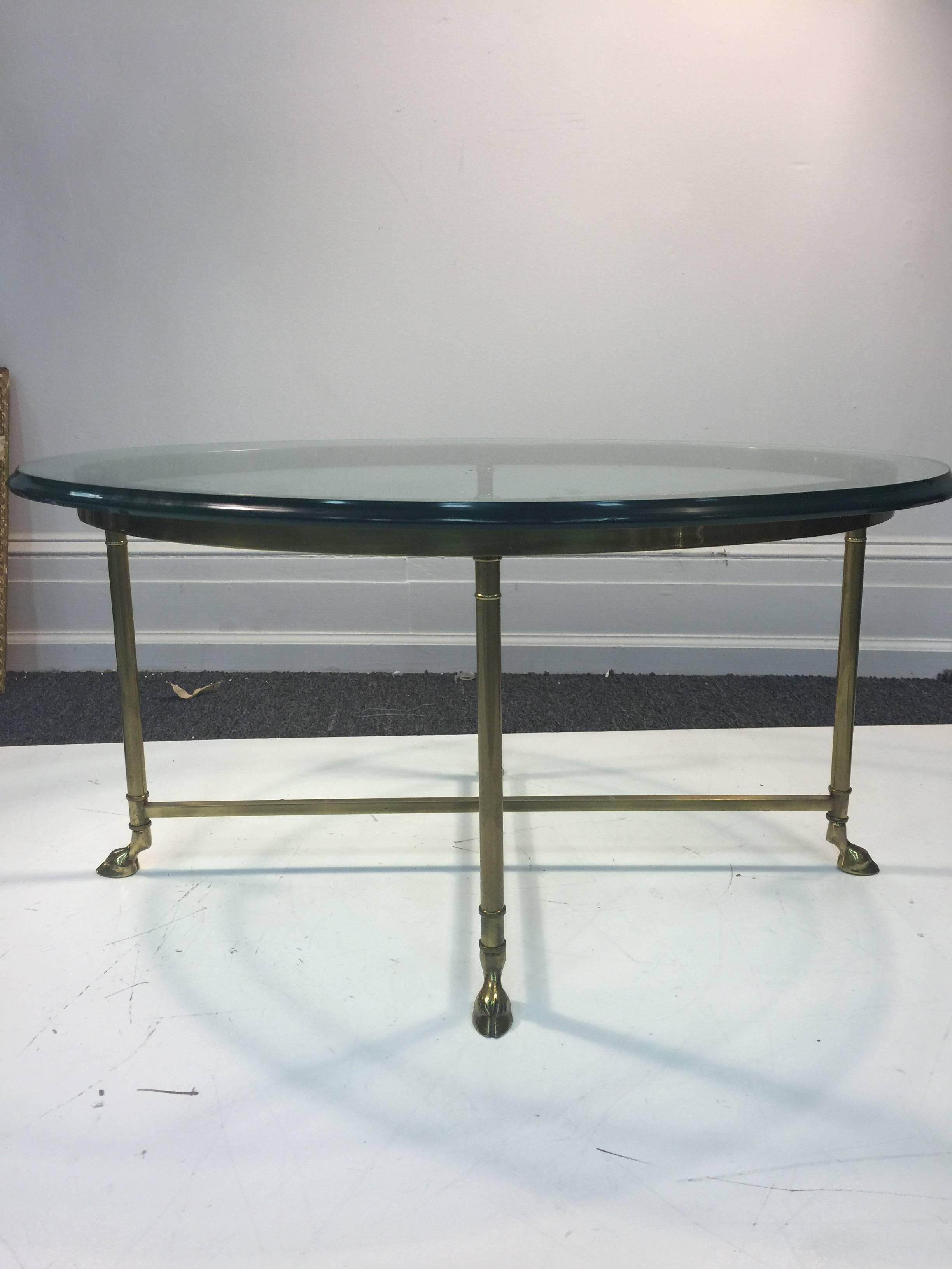 A beautiful brass coffee or cocktail table in the manner of Maison Jansen with X-base and hoof feet, circa 1970.