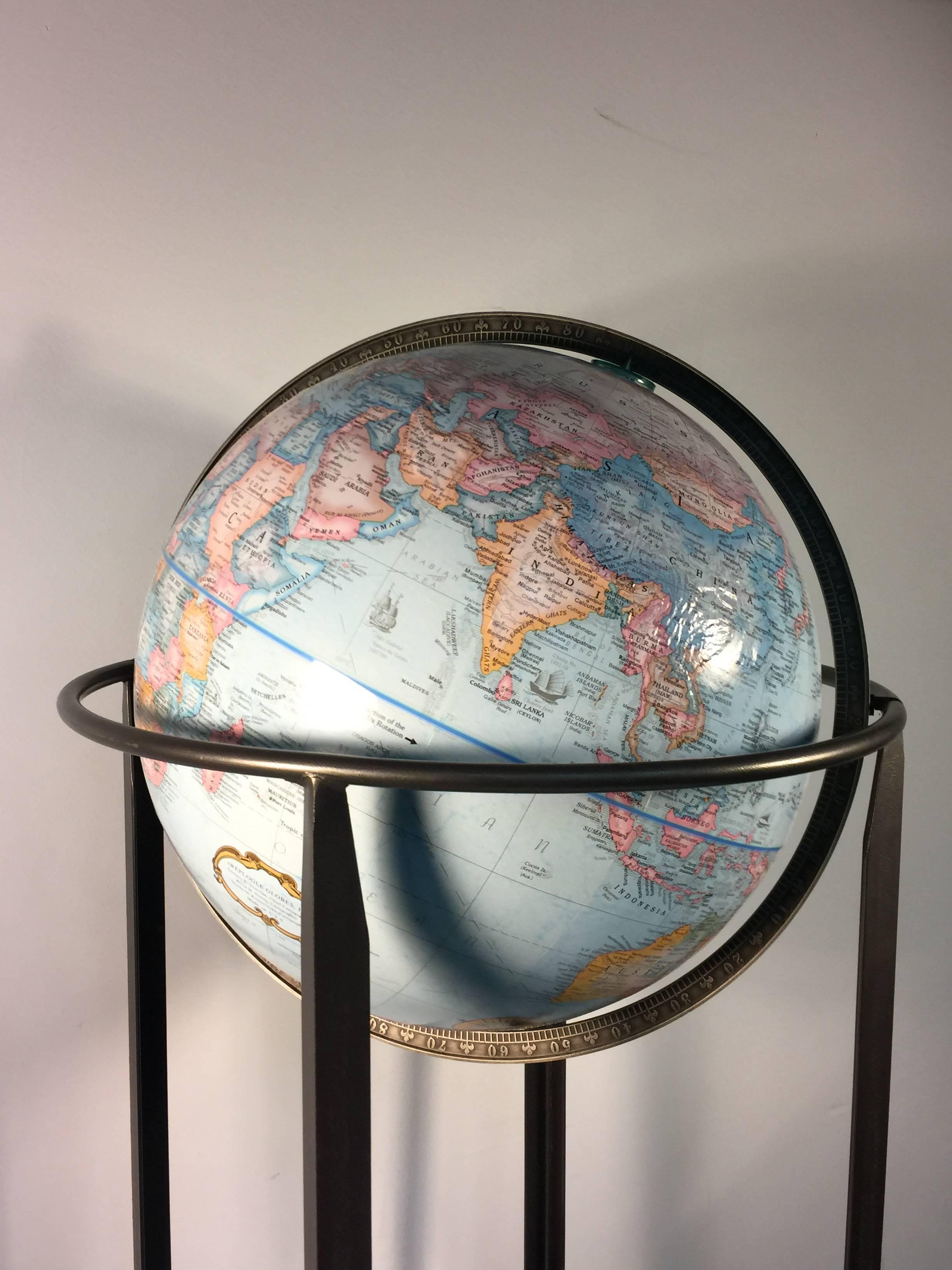 A great world globe on a modern iron stand, circa 1980.
