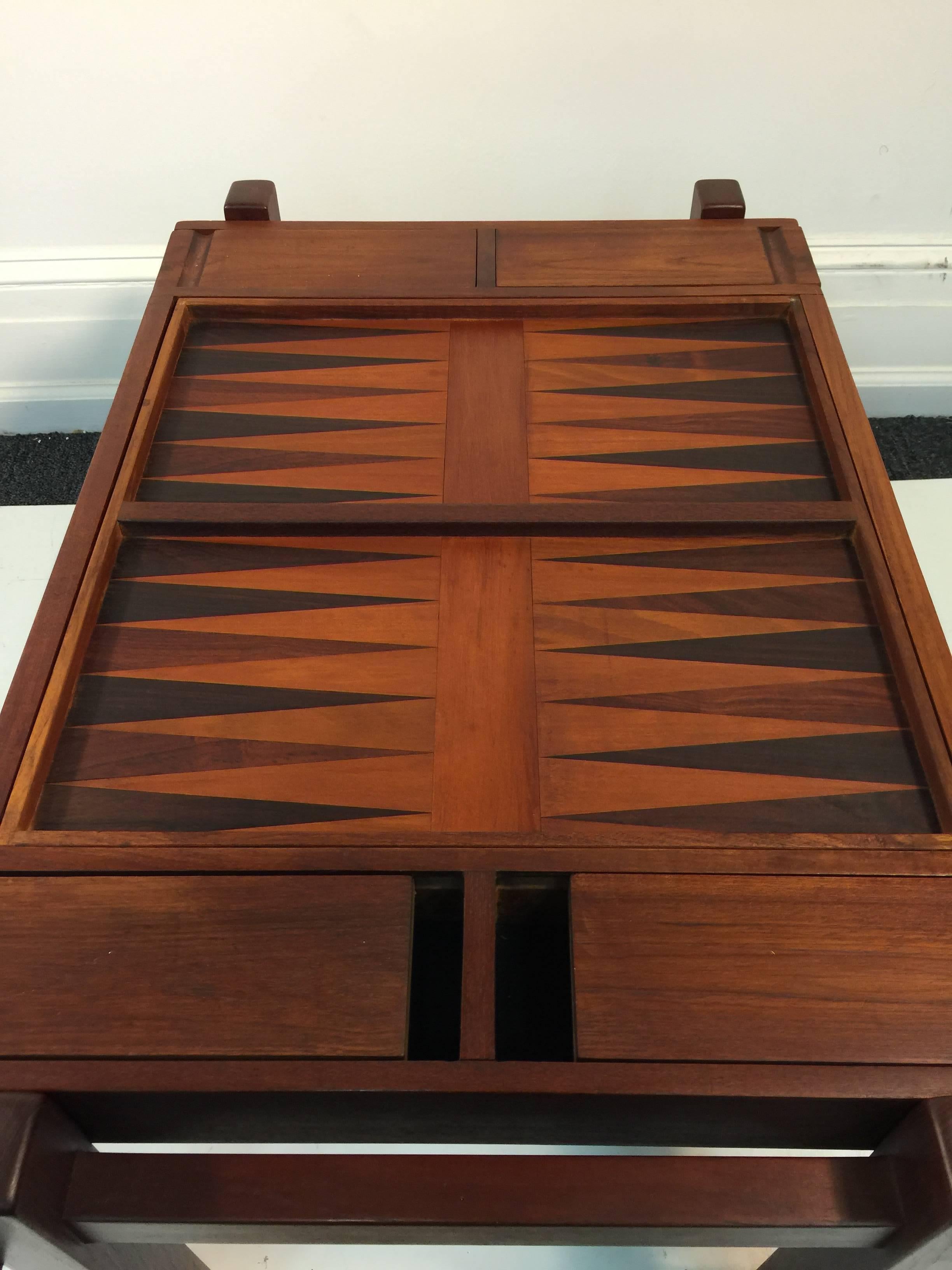 A fantastic Scandinavian Modern teak and rosewood game table for backgammon and chess made in Denmark with sliding compartments for game pieces.