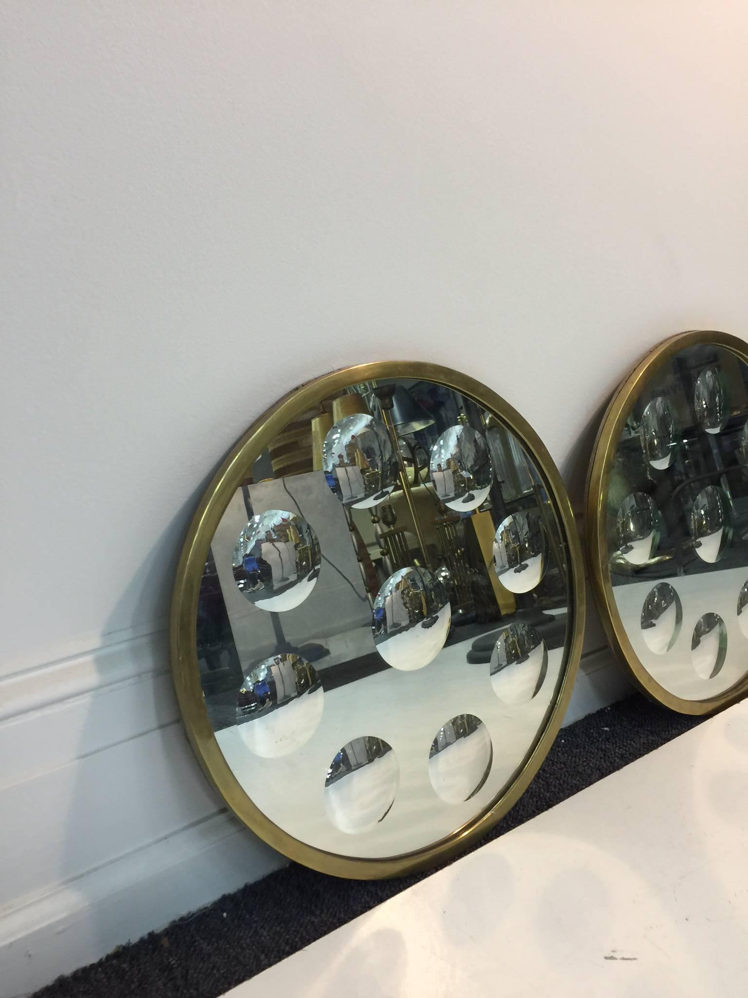 A fantastic pair of brass framed convex Op Art Italian wall mirrors by Piero Fornasetti, circa 1970.