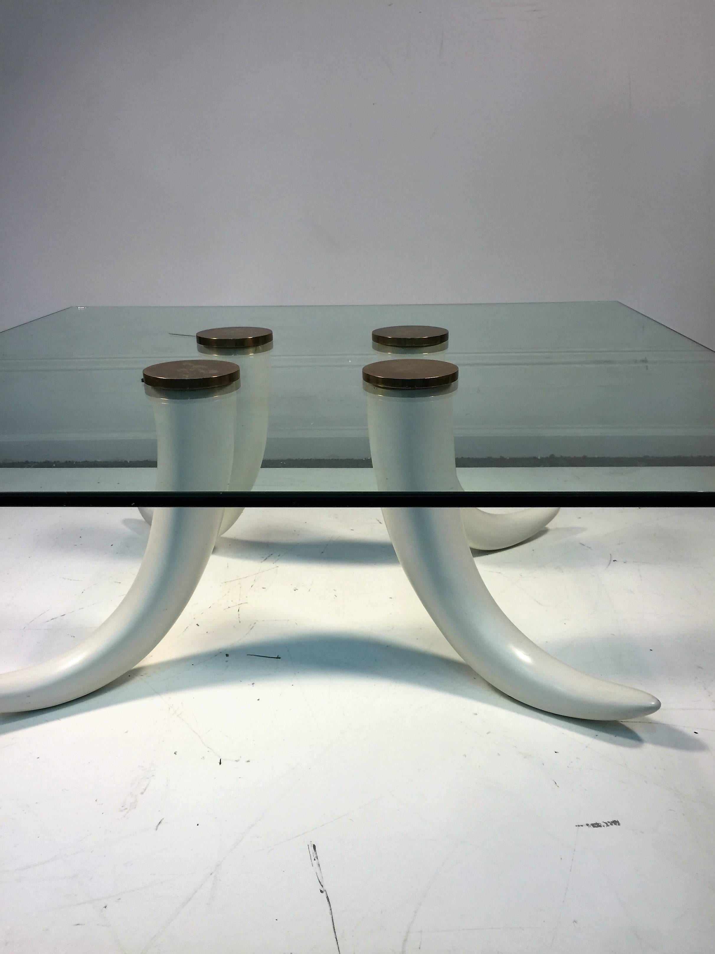 Simple yet dramatic composite cast tusk coffee table with solid brass Connecting caps. Would suit many modern interiors with the call of the wild
Yet totally humane subject. The glass top is 1/2