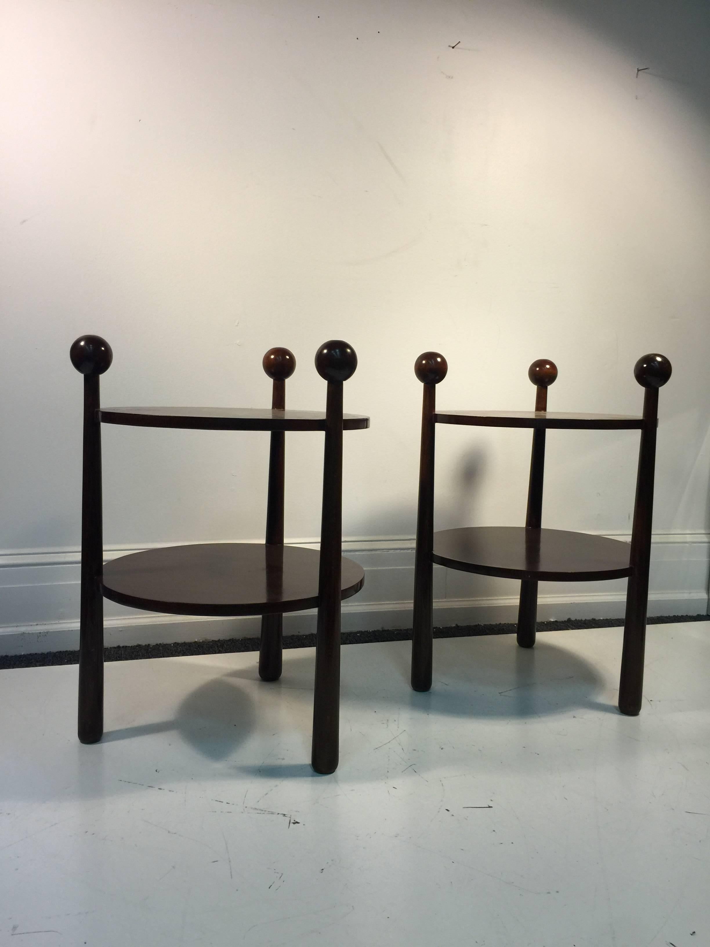 A fantastic pair of French two-tier wooden end or side tables with thick tripod base and ball accents. Great design, circa 1970.