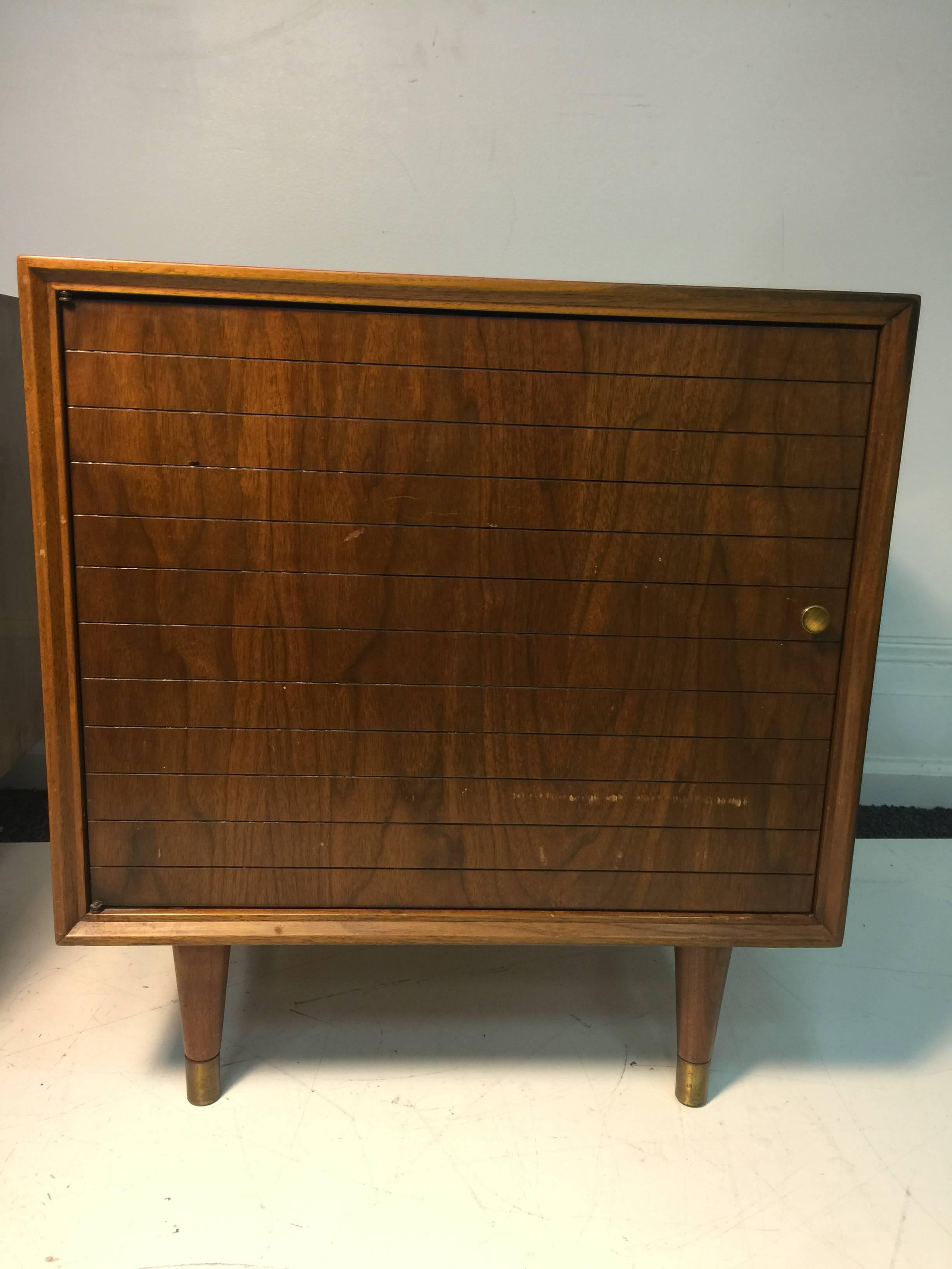 A magnificent pair of the night stands in the manner of Paul McCobb with tapered legs, and interior shelves for storage, circa 1960.