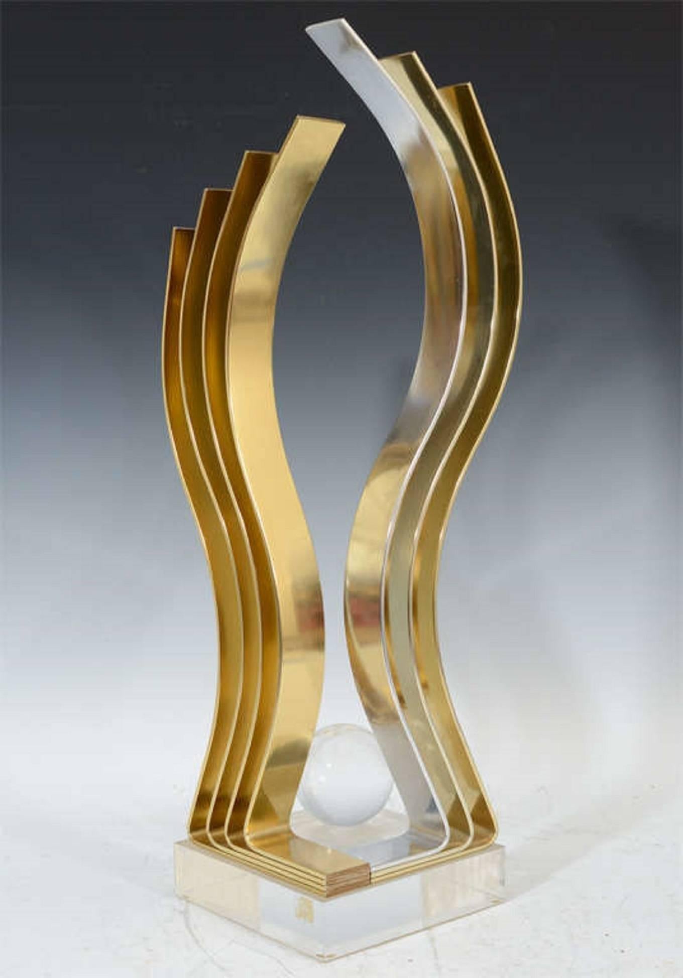 An amazing modern kinetic sculpture by Dan Murphy in brass, chrome and Lucite. The piece is signed, and dated 1989.