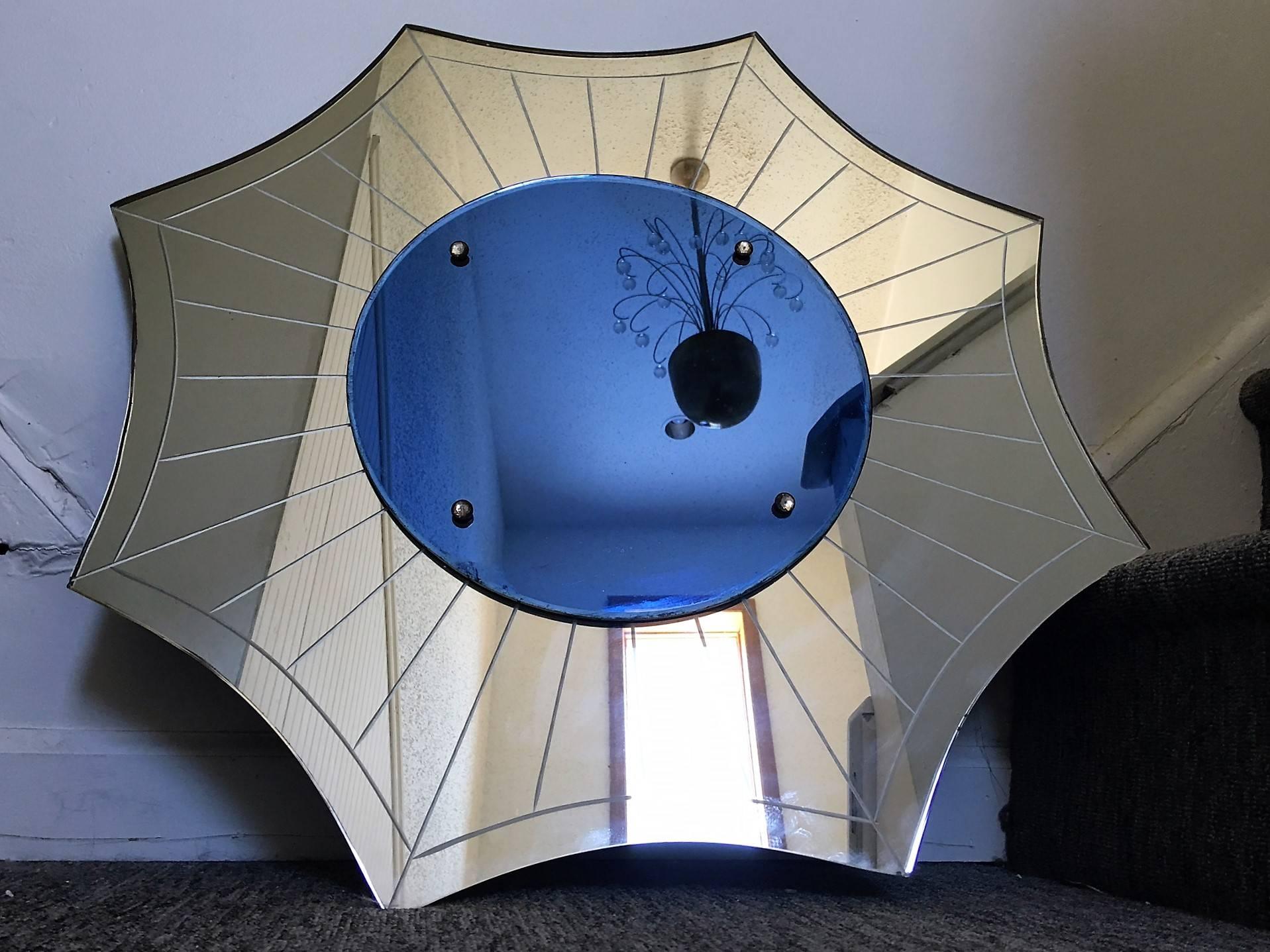 Great star form Art Deco mirror with etched line and border design with center round cobalt blue mirror. Blue mirror held with four faceted glass gem details, this mirror is a dramatic accent for any wall in an high end setting. In excellent