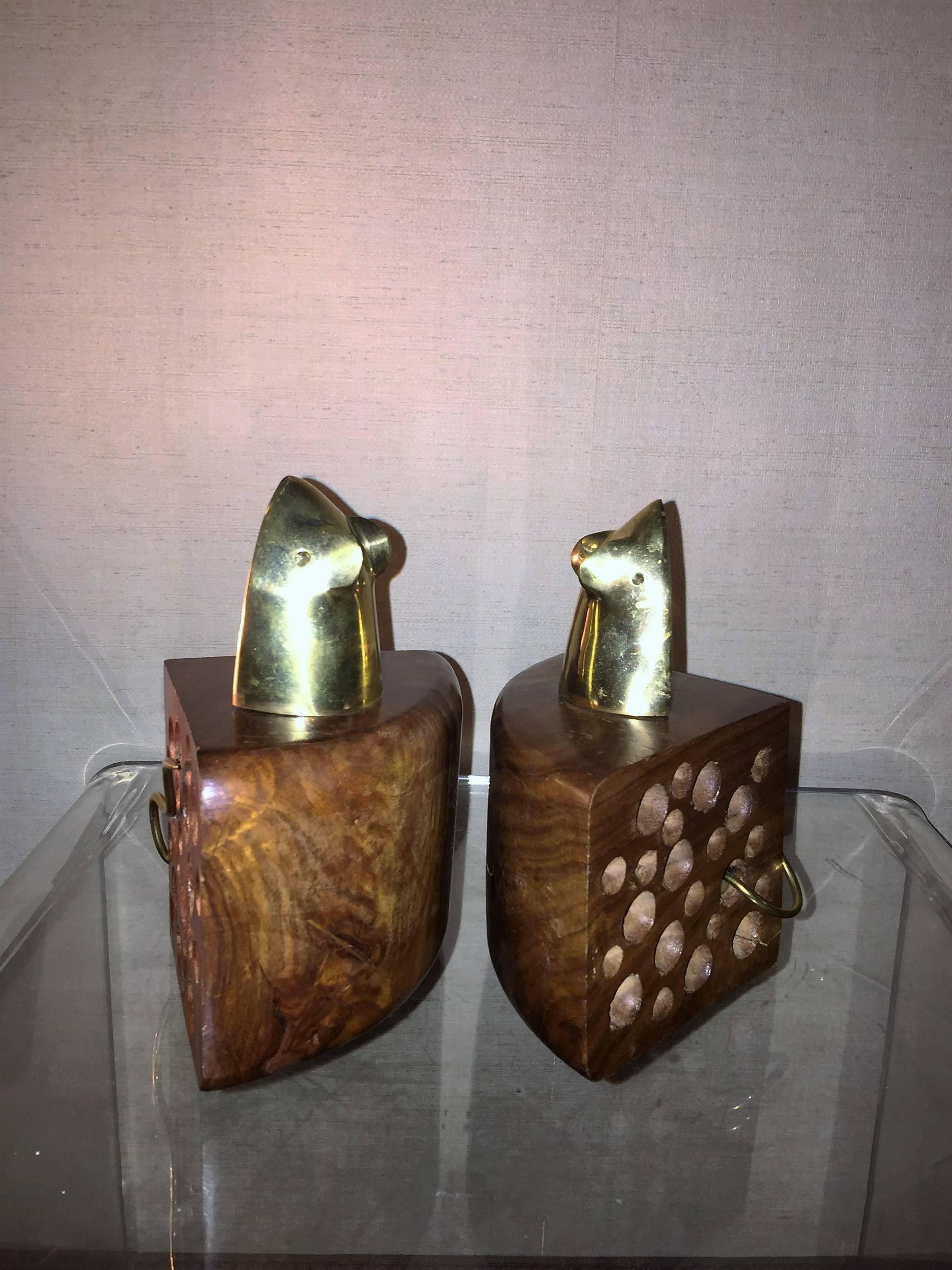 Adorable and well-made brass mouse and carved walnut cheese wedge bookends. Each with a stylized brass mouse with trailing tail poking out of a wedge of cheese hand-carved walnut block of cheese is done beautifully with the modernist brass mouse