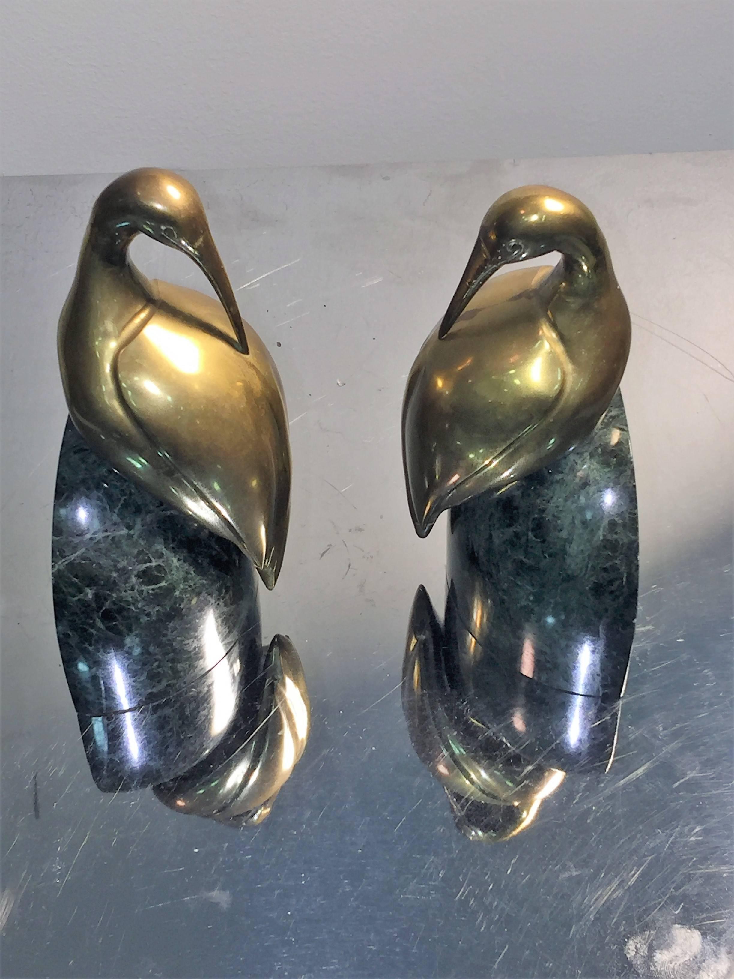 Beautifully done stylized brass egrets mounted on rounded and polished green marble bases. Great Fauna form bookends for your console or coffee table setting.
